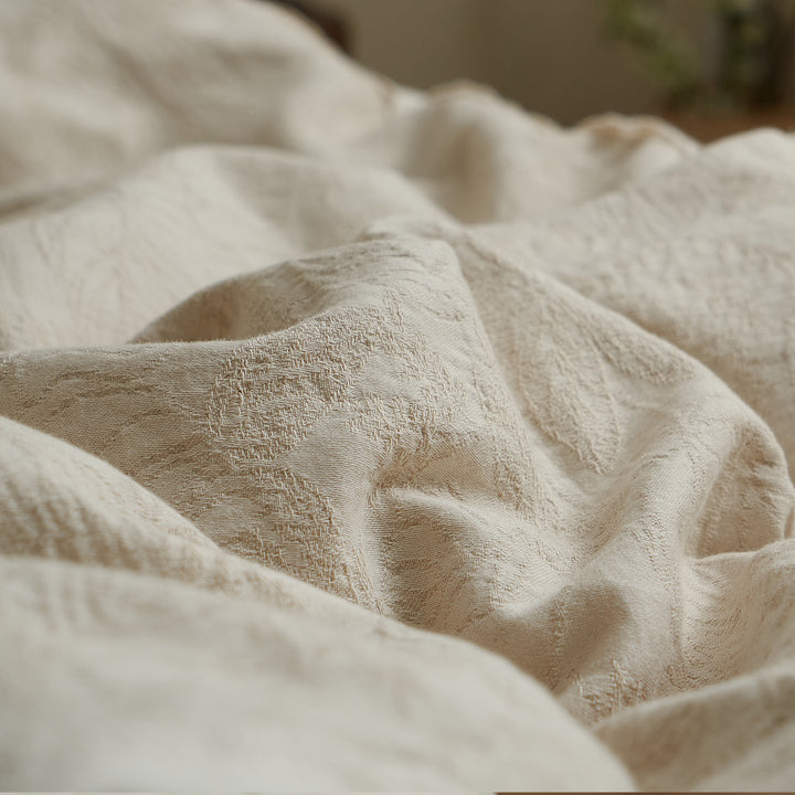 Close-up of the yarn-dyed botanical jacquard pattern and natural texture of the cotton-linen fabric.