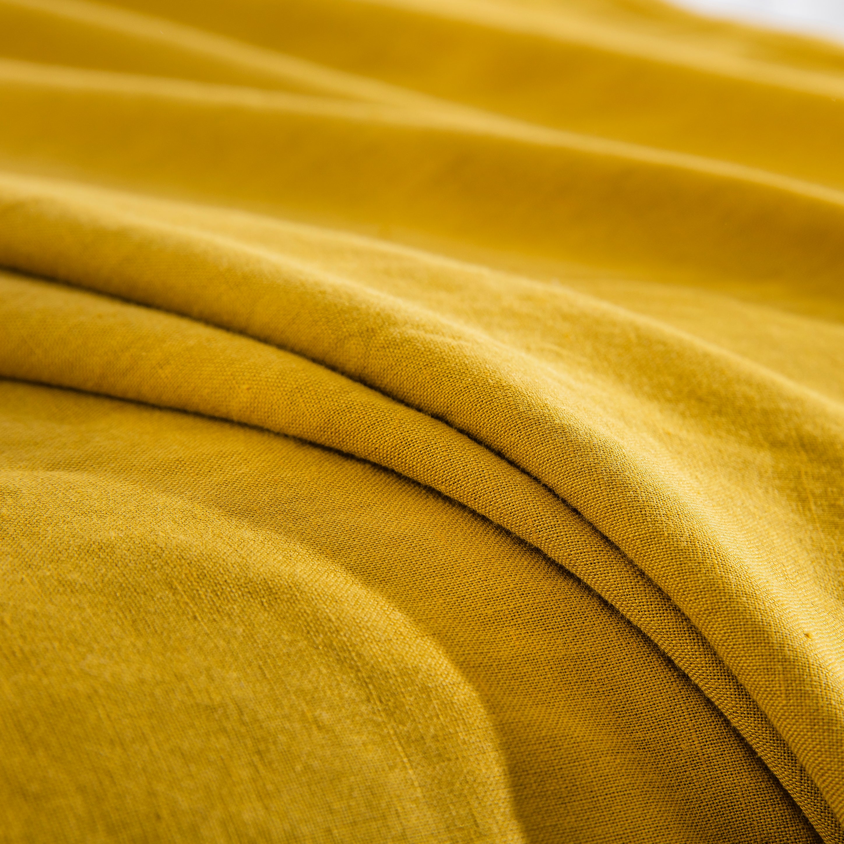 Detailed fabric texture of the premium 55% European flax linen and 45% natural cotton blend in mustard yellow - DAUAOTO