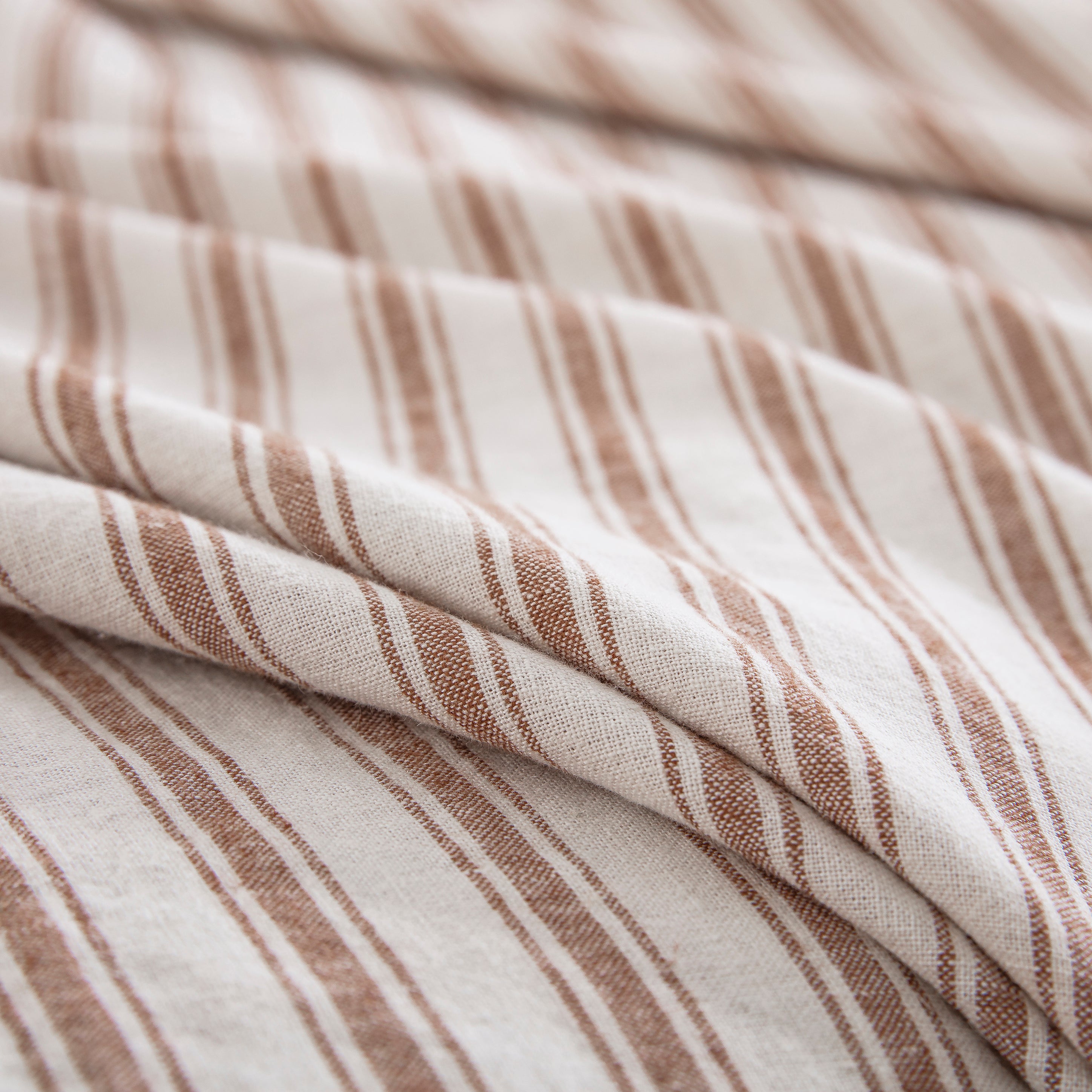 Tactile rustic texture of the 55% European flax linen and 45% natural cotton blend in caramel stripe - DAUAOTO