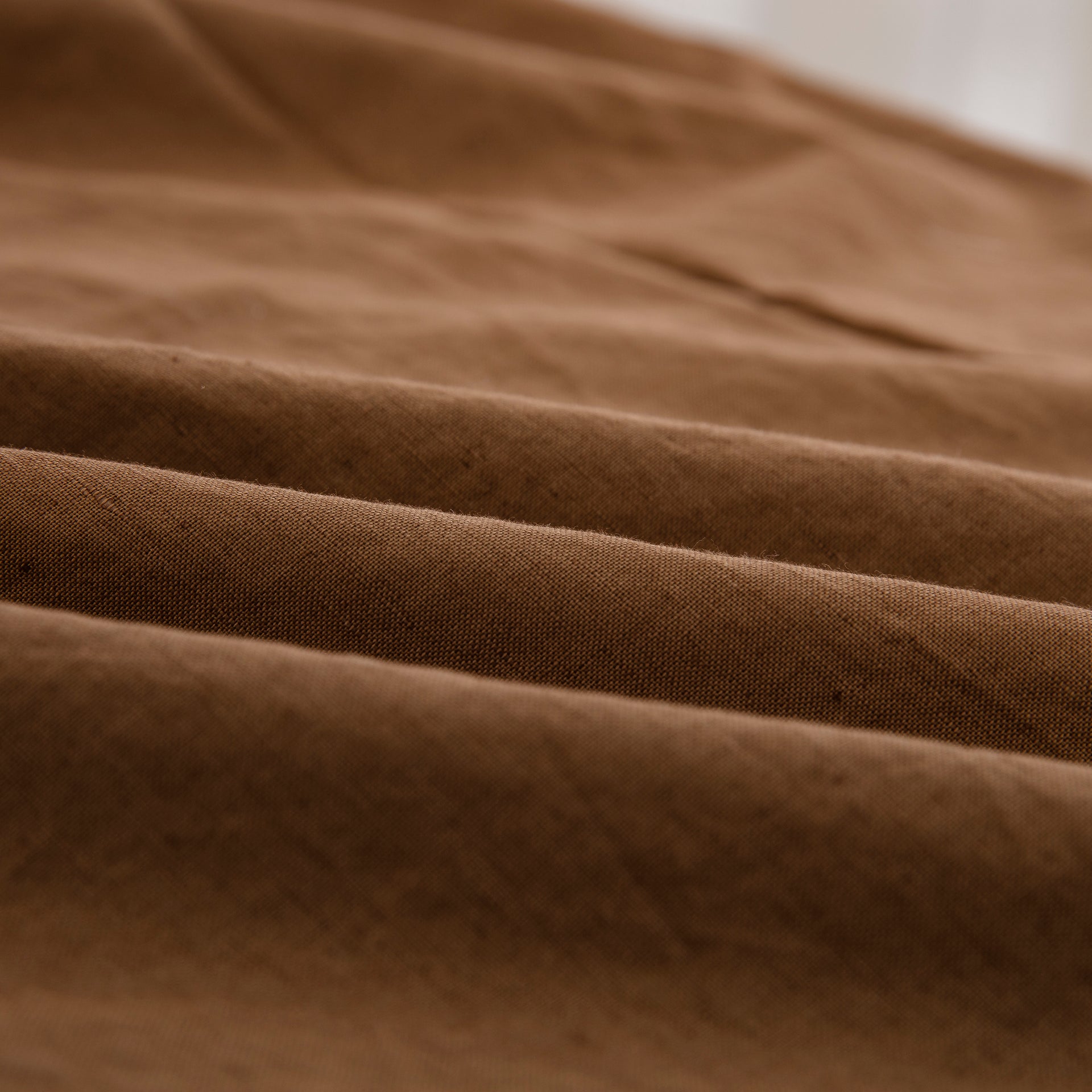 Close-up of the highly breathable 55% European flax linen and 45% natural cotton blend fabric in a warm terracotta hue - DAUAOTO