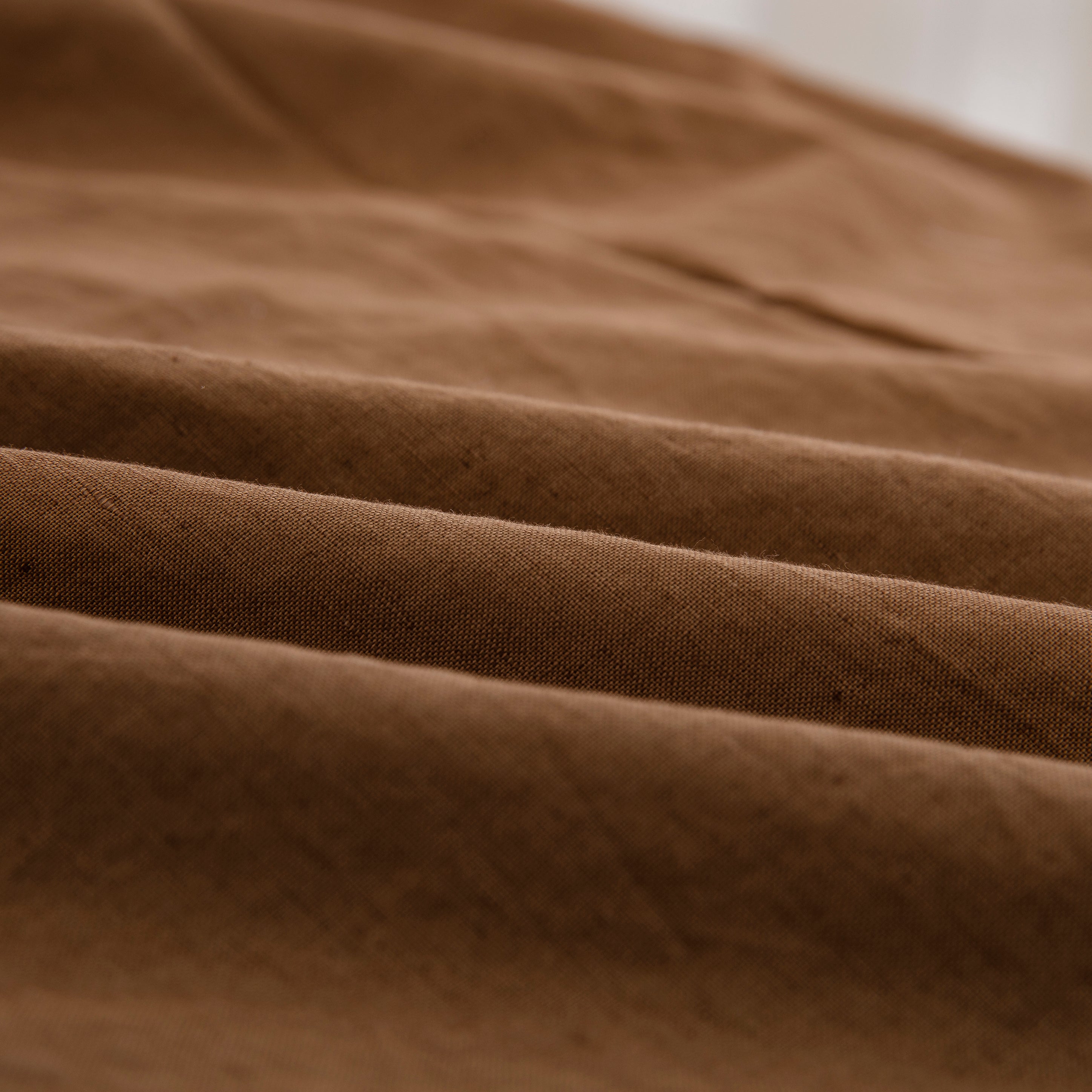 Close-up of the highly breathable 55% European flax linen and 45% natural cotton blend fabric in a warm terracotta hue - DAUAOTO