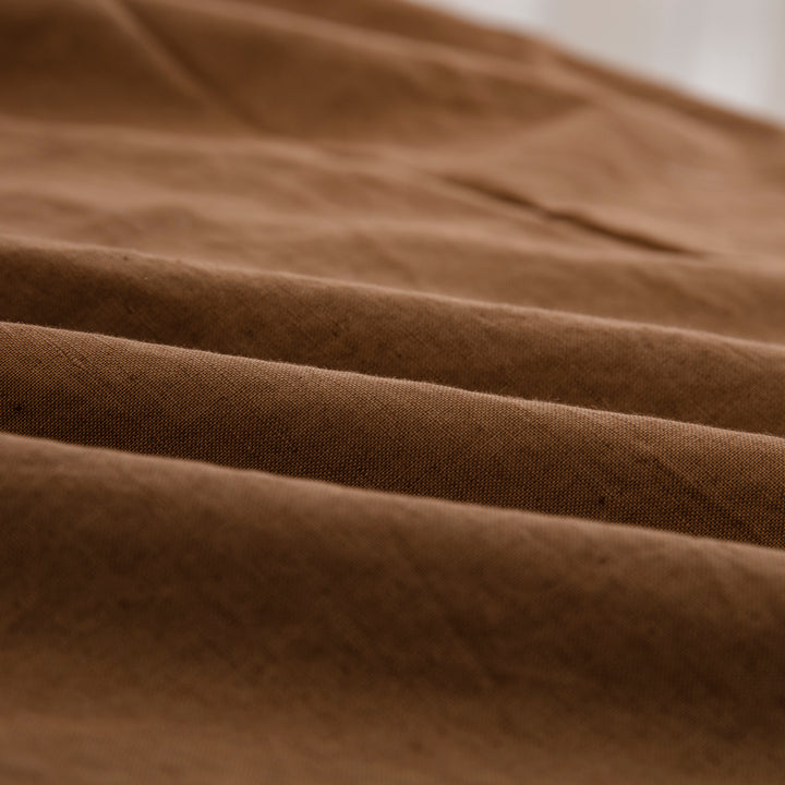 Close-up of the highly breathable 55% European flax linen and 45% natural cotton blend fabric in a warm terracotta hue - DAUAOTO