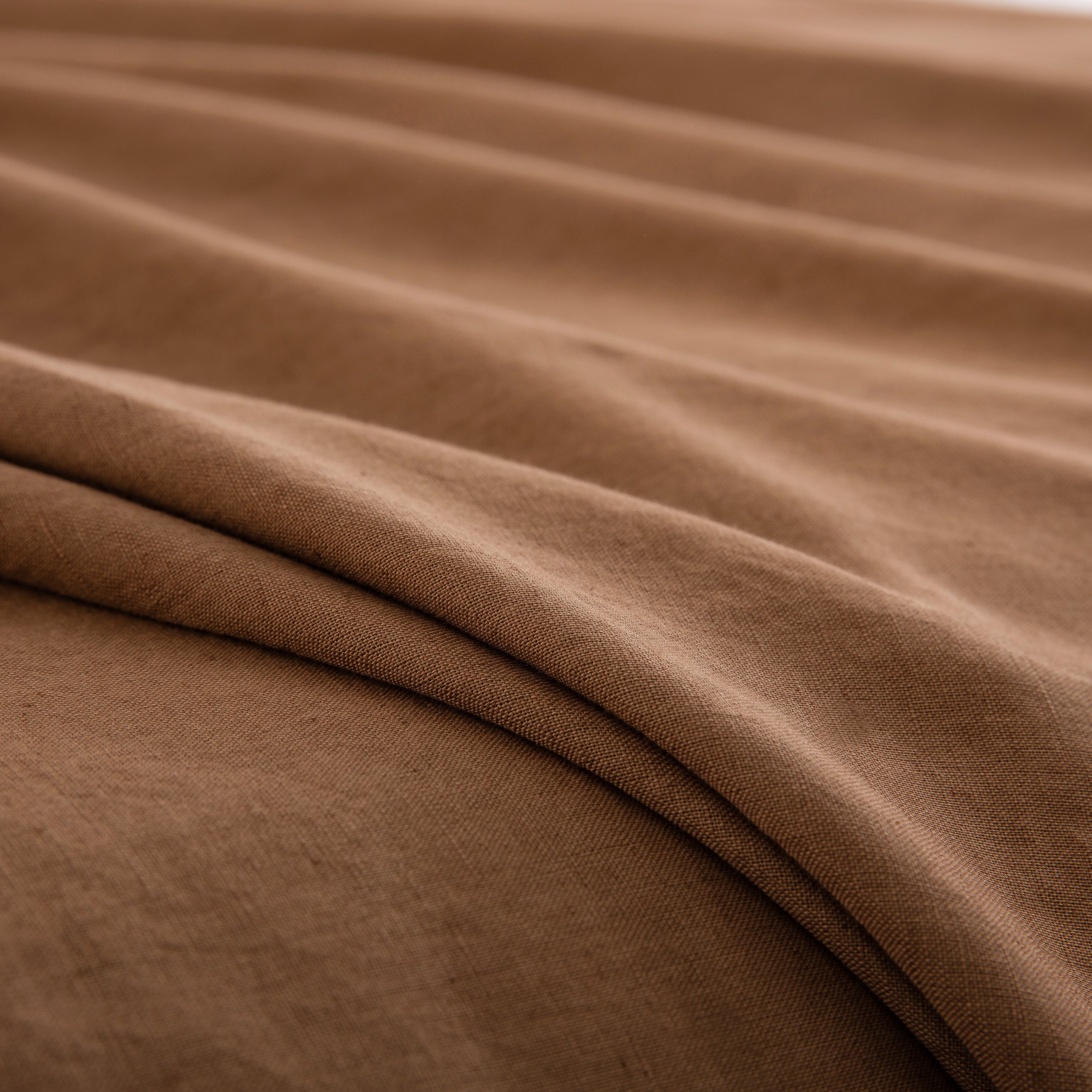 Close-up of the deeply comforting rustic texture of 55% European flax linen and 45% natural cotton in cognac brown - DAUAOTO