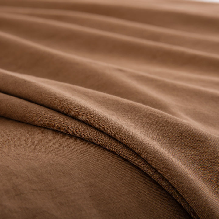 Close-up of the deeply comforting rustic texture of 55% European flax linen and 45% natural cotton in cognac brown - DAUAOTO