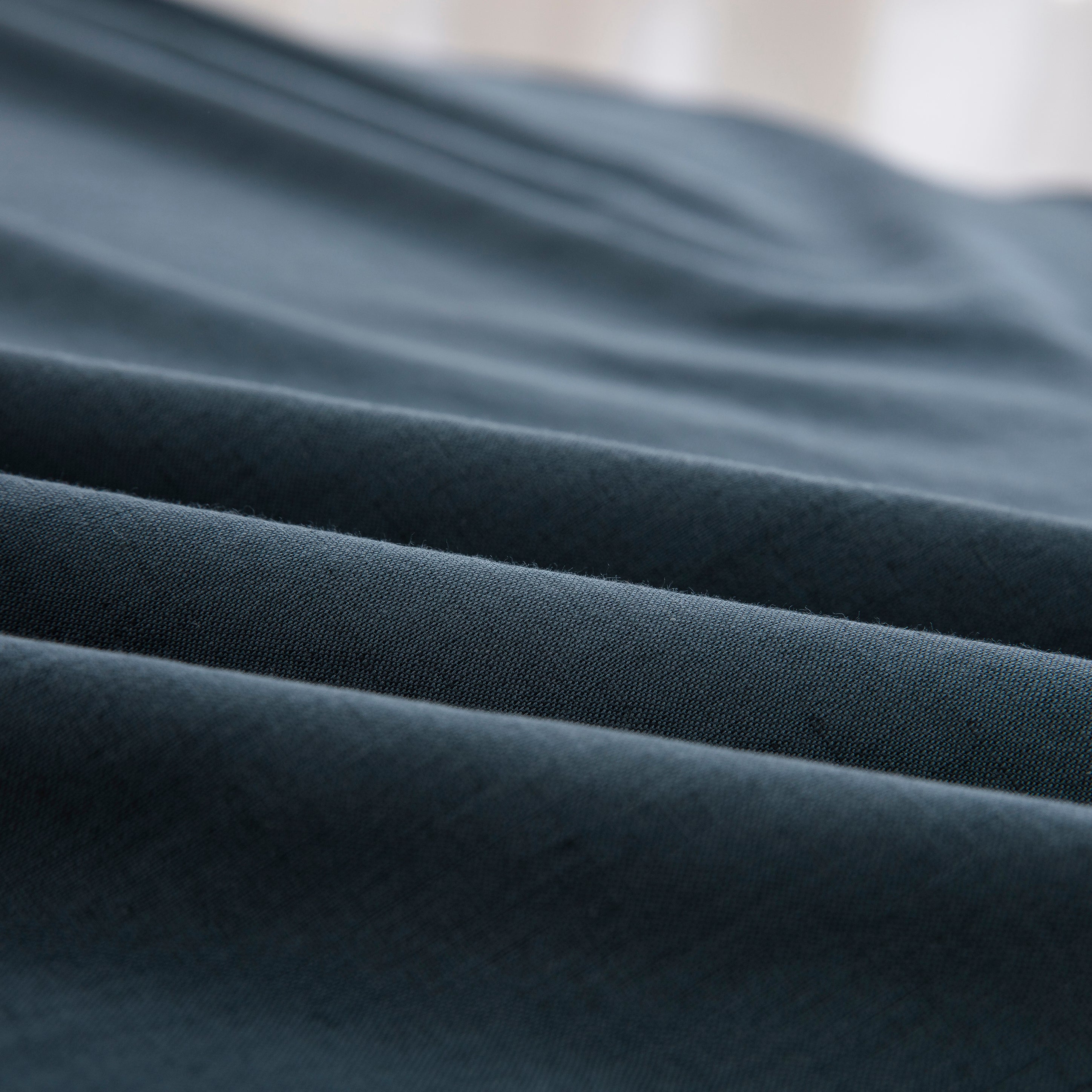 Close-up of the highly breathable 55% European flax linen and 45% natural cotton blend fabric in a moody slate blue hue - DAUAOTO