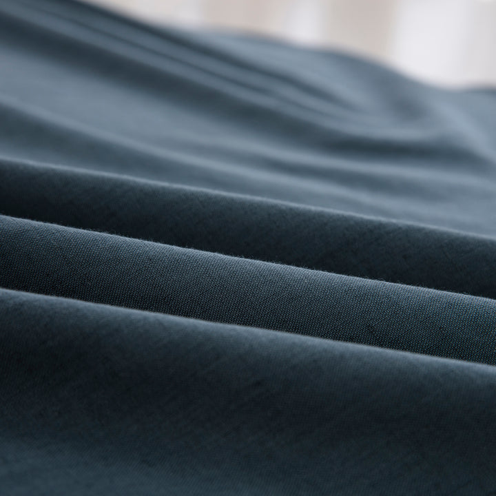 Close-up of the highly breathable 55% European flax linen and 45% natural cotton blend fabric in a moody slate blue hue - DAUAOTO