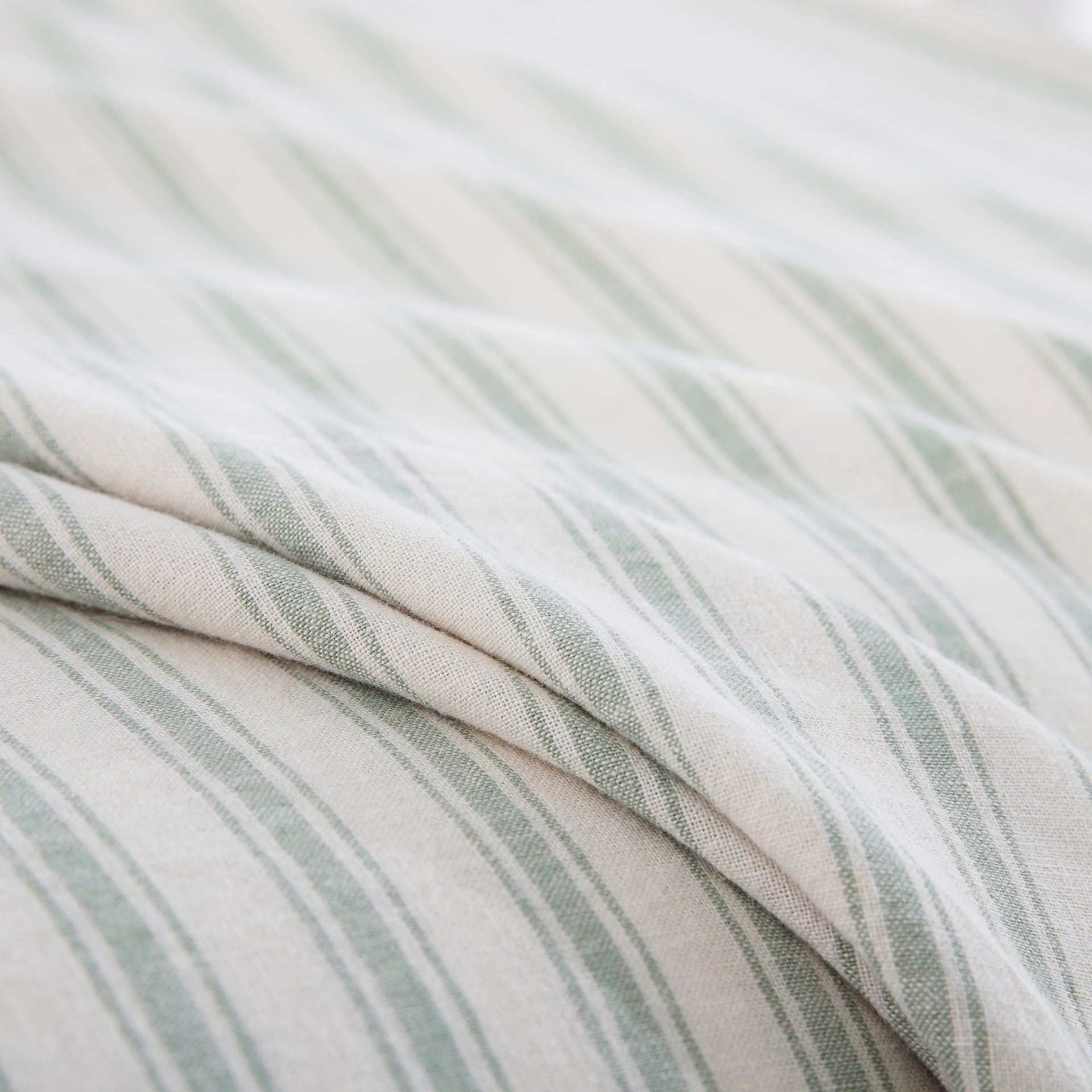 Close-up of the premium 55% European flax linen and 45% natural cotton blend fabric in a soothing sage green stripe - DAUAOTO