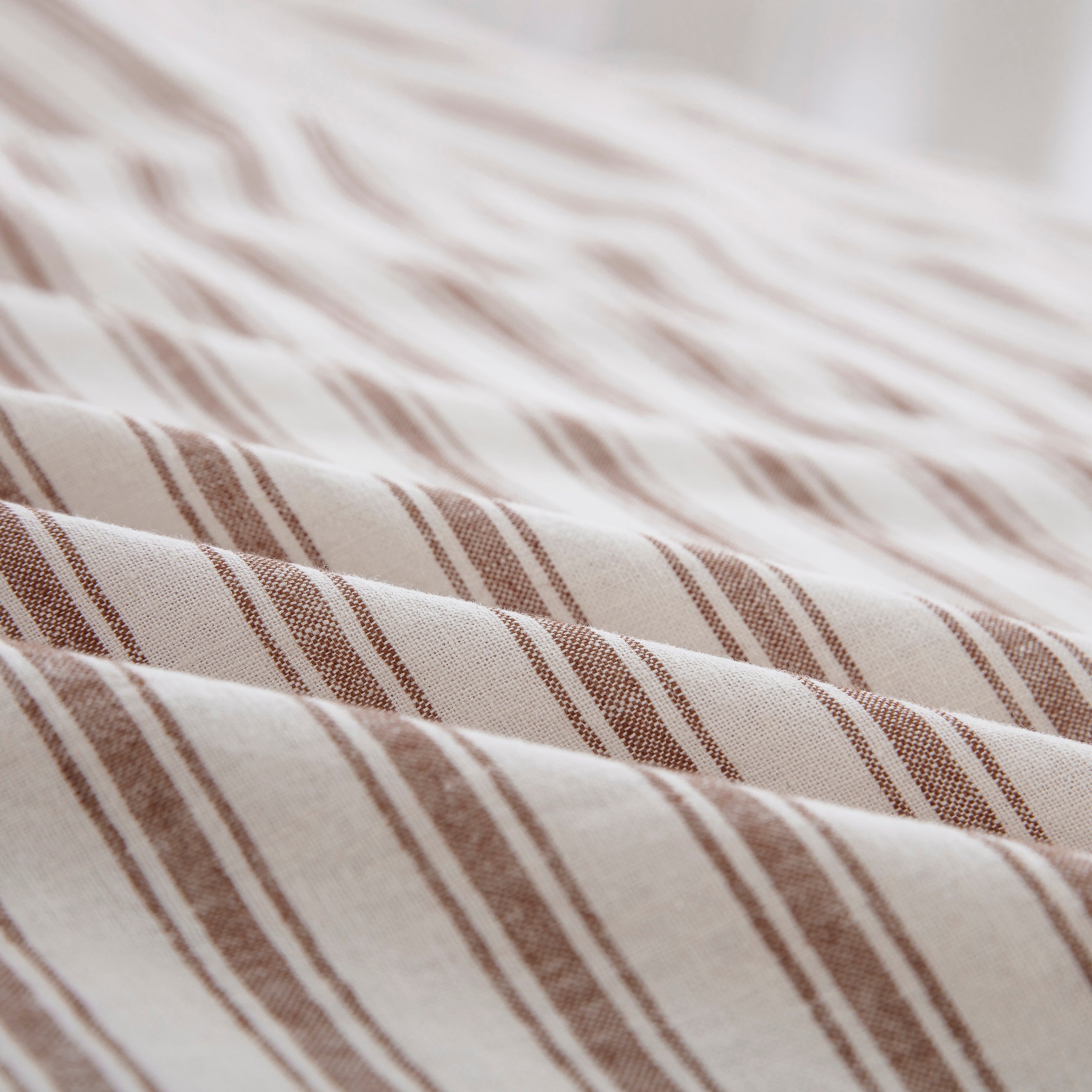 Close-up of the tactile lived-in texture and exceptional color depth of the yarn-dyed taupe striped sheet fabric - DAUAOTO