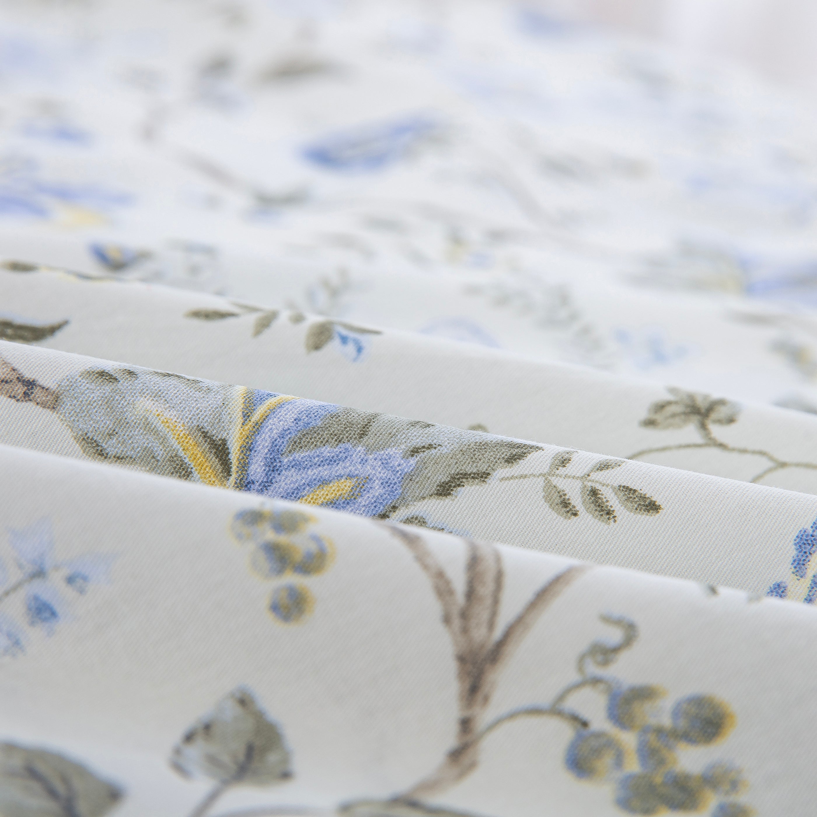 Folded DAUAOTO Provence blue botanical cotton bed sheets highlighting the smooth, breathable, and lightweight fabric texture.