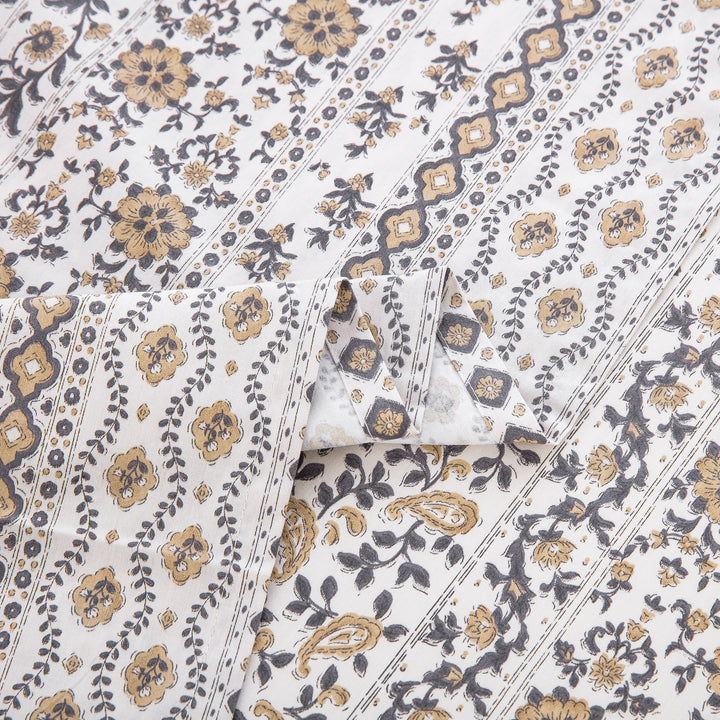Close-up showing the elegant folded edges and earthy geometric print of the DAUAOTO bohemian cotton sheets.