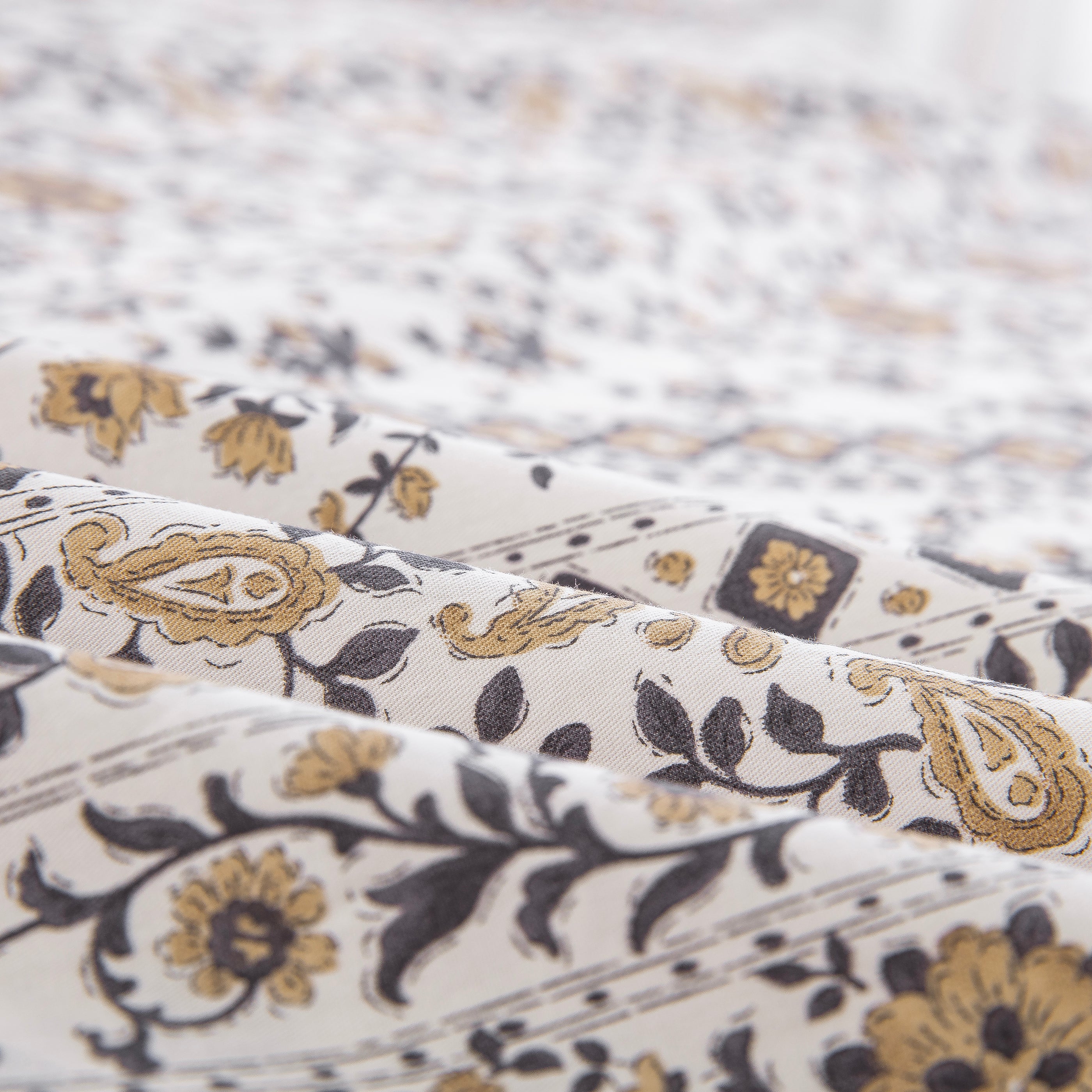 Folded DAUAOTO vintage block print boho cotton bed sheets highlighting the smooth, breathable, and lightweight fabric texture.