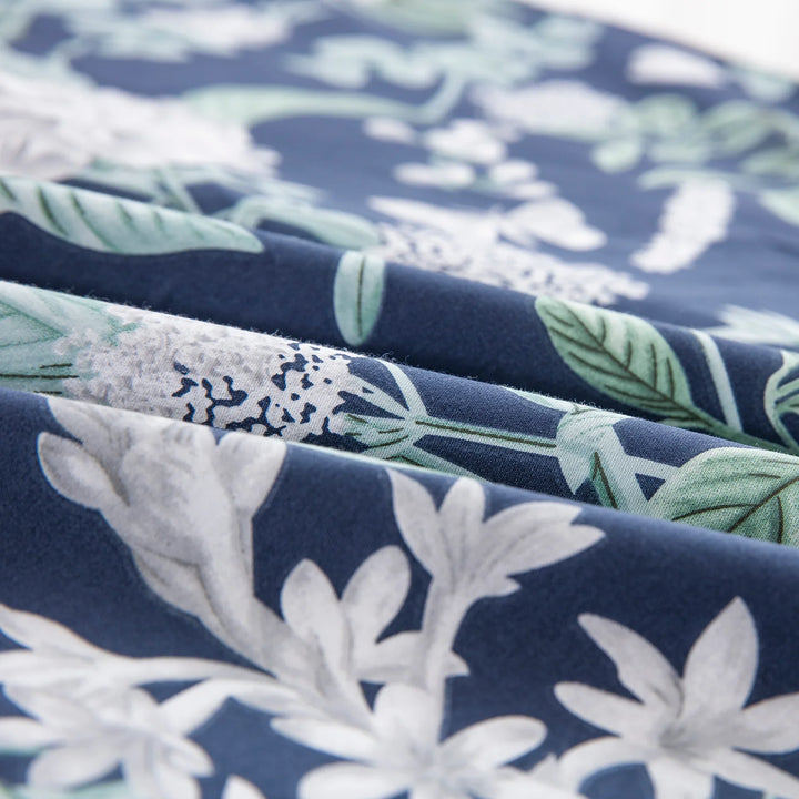Ultra-soft breathable 100% cotton fabric drape showing white botanical florals on navy blue - DAUAOTO