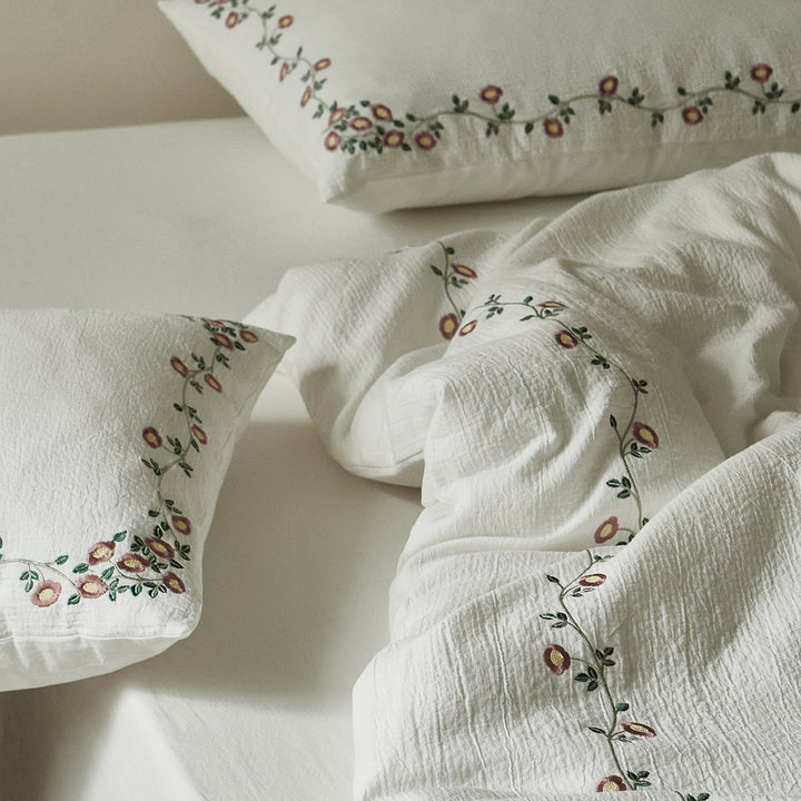 Soft ivory duvet cover and pillow sham with coordinated floral embroidery