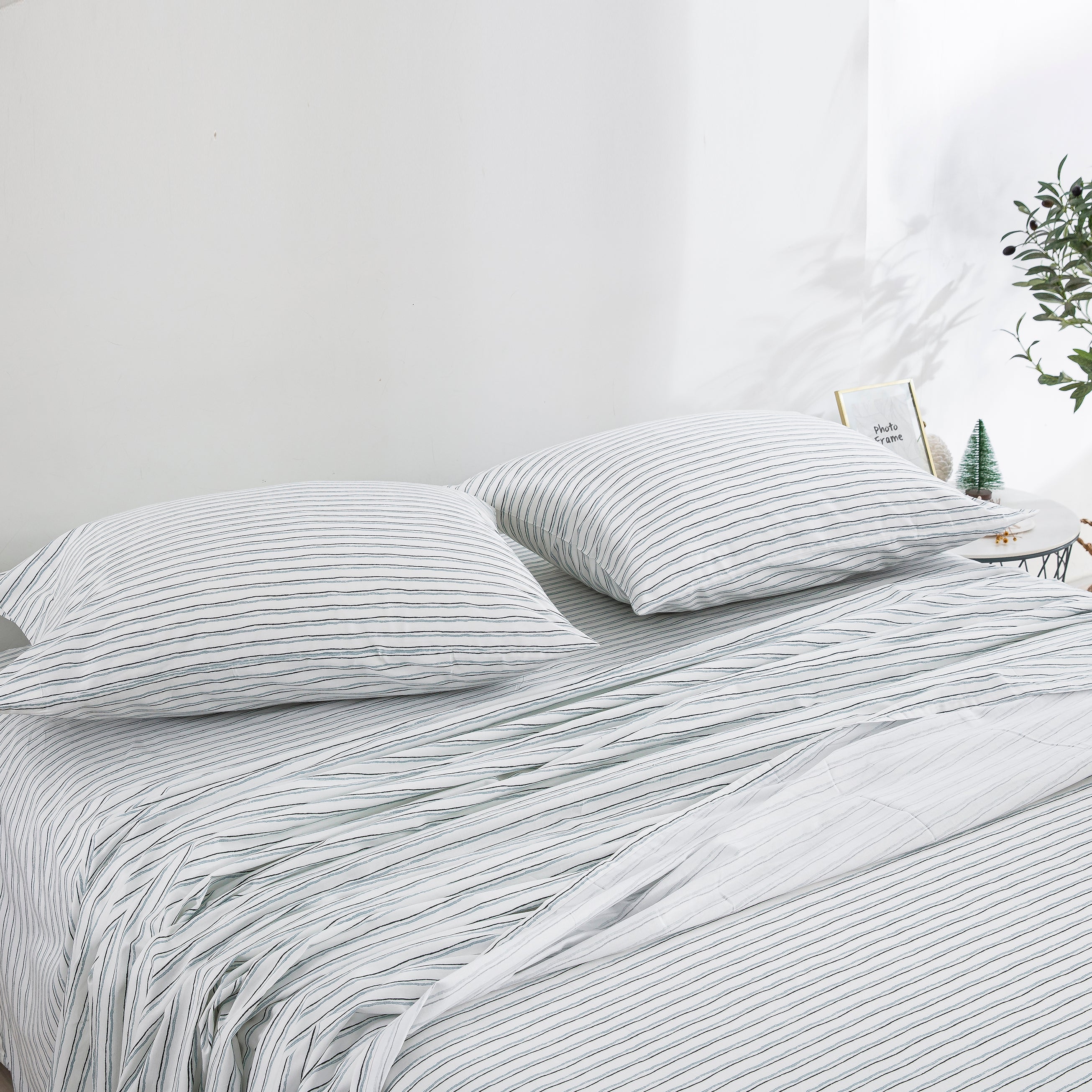 Casual farmhouse aesthetic bedroom styled with the versatile soft blue hand-painted stripe cotton sheets - DAUAOTO