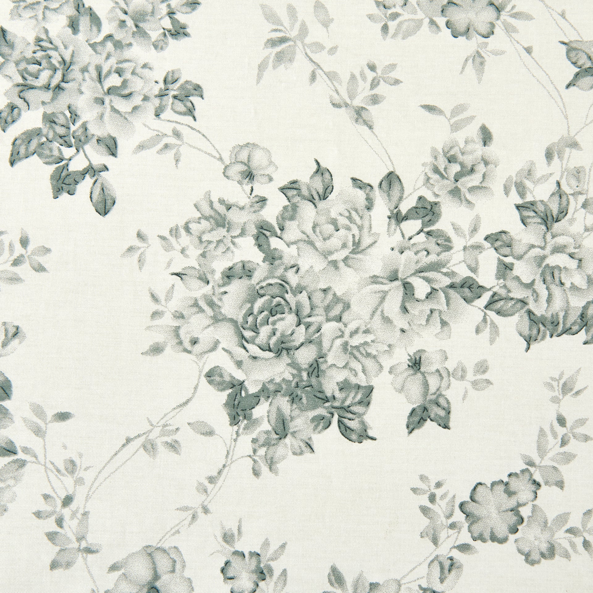 Close-up of the traditional pale black rose pattern delicately printed on crisp light ground cotton fabric - DAUAOTO