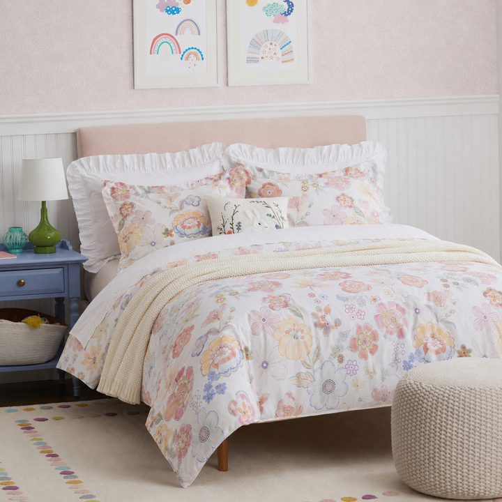 Angled view of a bright, inviting bedroom featuring the DAUAOTO pastel blossom floral cotton bedding.