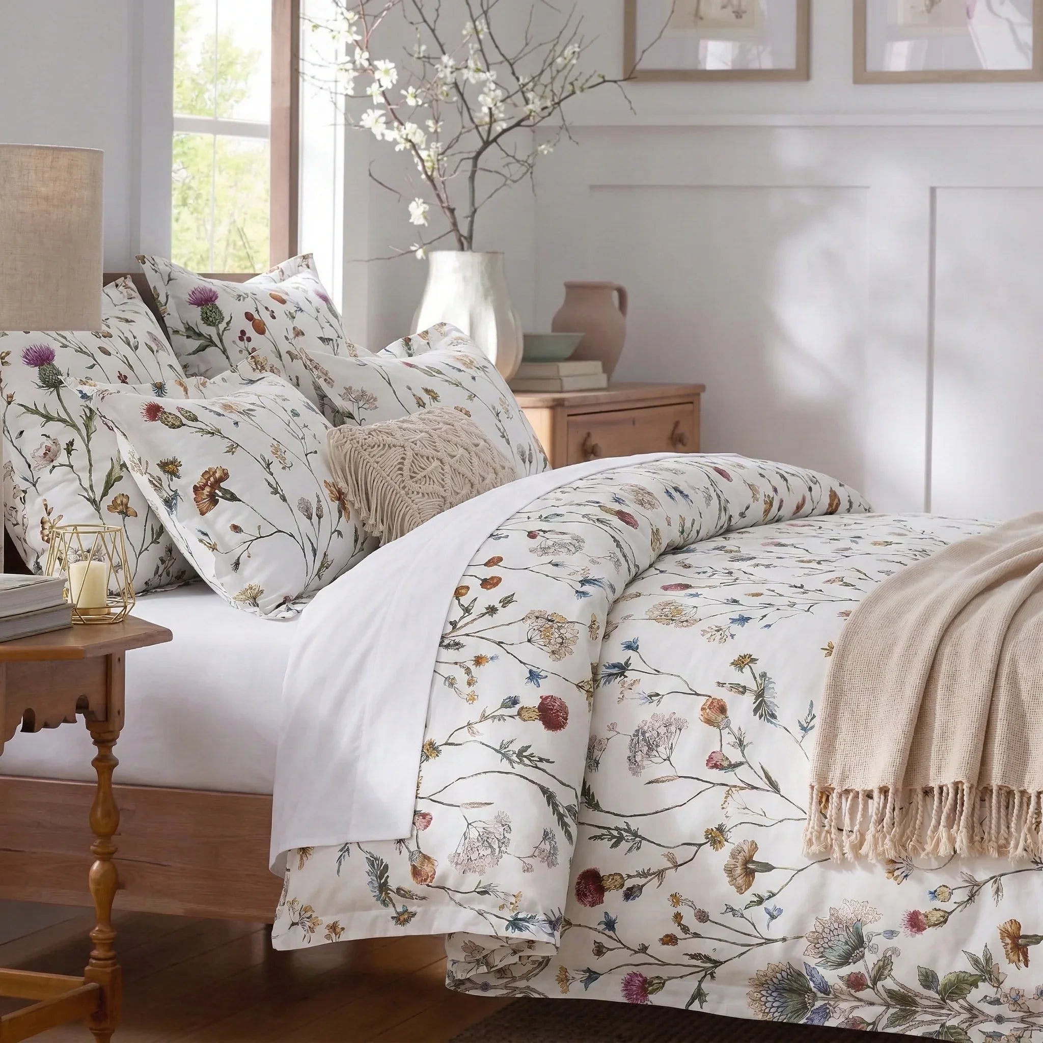 Elegant spring meadow floral duvet cover draped over a wooden bed with matching pillows - DAUAOTO