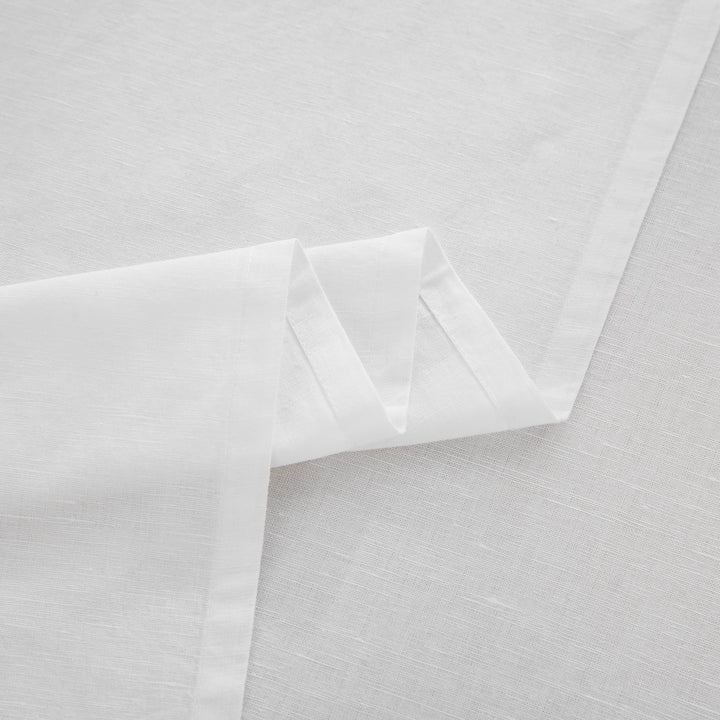 Detailed view of the beautifully draped flat sheet highlighting the rustic texture of the linen blend - DAUAOTO