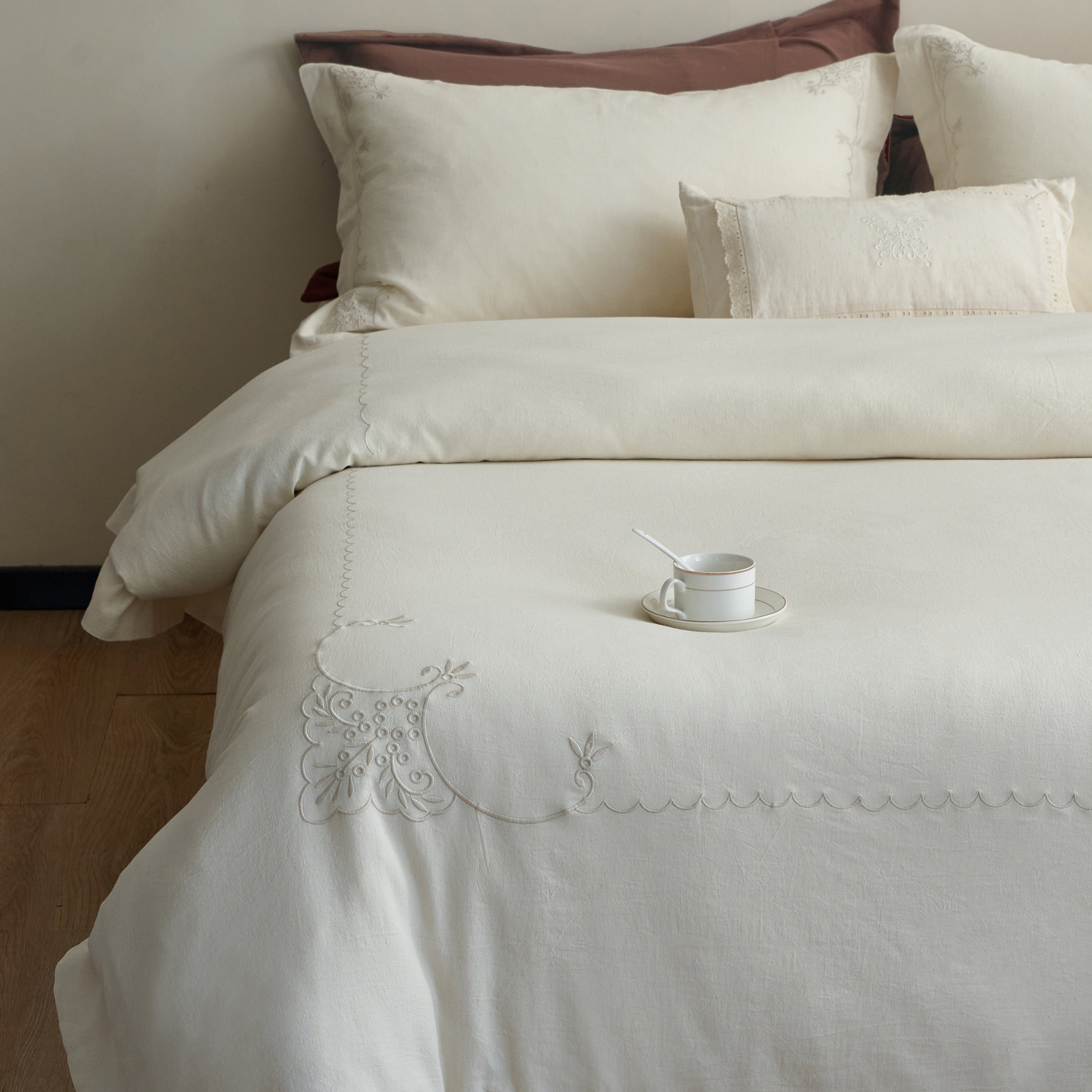 Front view of the Aveline linen-cotton duvet cover set with coordinated pillow shams and ornamental embroidery.