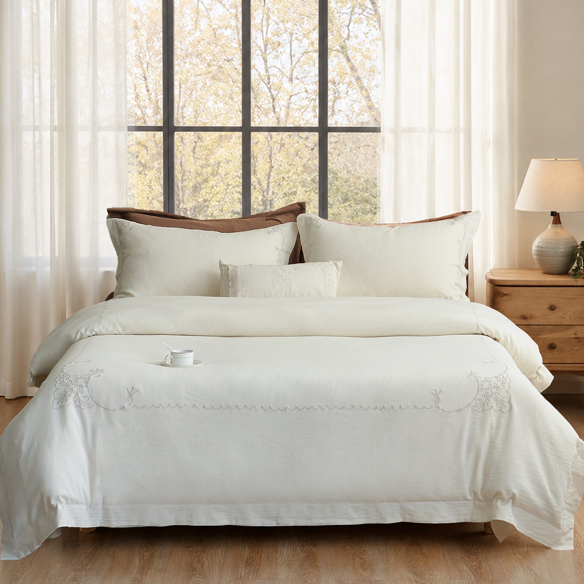 Aveline embroidered linen-cotton duvet cover set styled in a warm neutral bedroom with tone-on-tone embroidery.