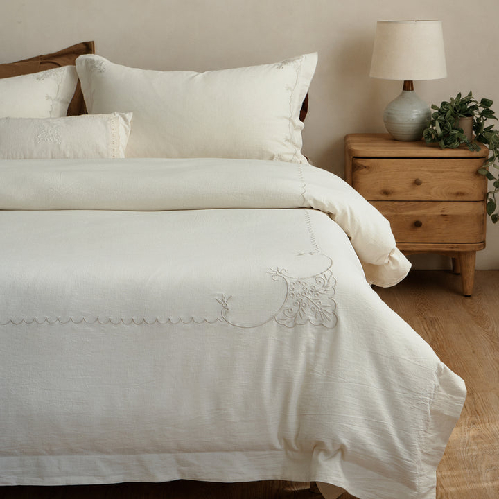 Aveline natural ivory linen-cotton duvet cover set displayed in a softly styled bedroom.