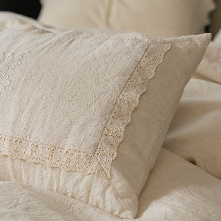 Detail shot of the heavy custom lace and vintage embroidery stitching on the Fontainebleau pillowcase edge.