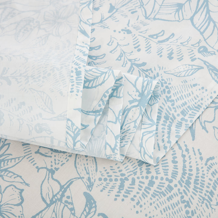 Detailed view of the delicately drawn light blue floral vine gracefully winding across off-white cotton - DAUAOTO