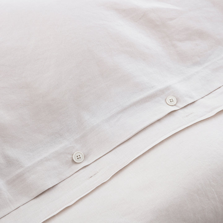 Discreet hidden button closure on the dove grey duvet cover representing traditional premium craftsmanship - DAUAOTO