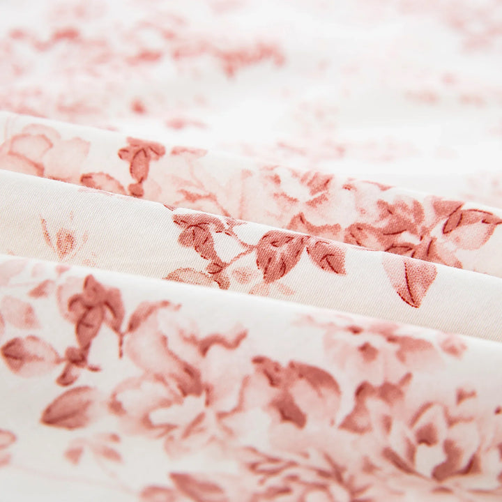 Close-up of the ultra-soft pure cotton fabric showing the dusty pink and soft rose floral pattern on a warm cream ground - DAUAOTO