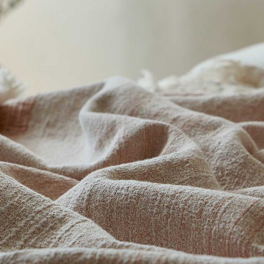 Close-up of the breathable dusty rose linen blend fabric showing its natural crinkle texture.