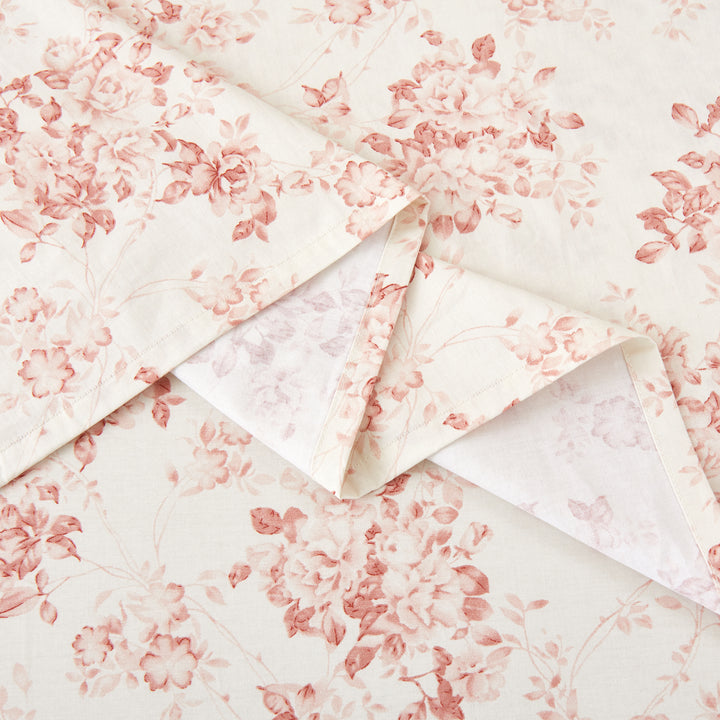 Detailed view of the elegantly crafted flat sheet hem with traditional pale rose floral pattern - DAUAOTO