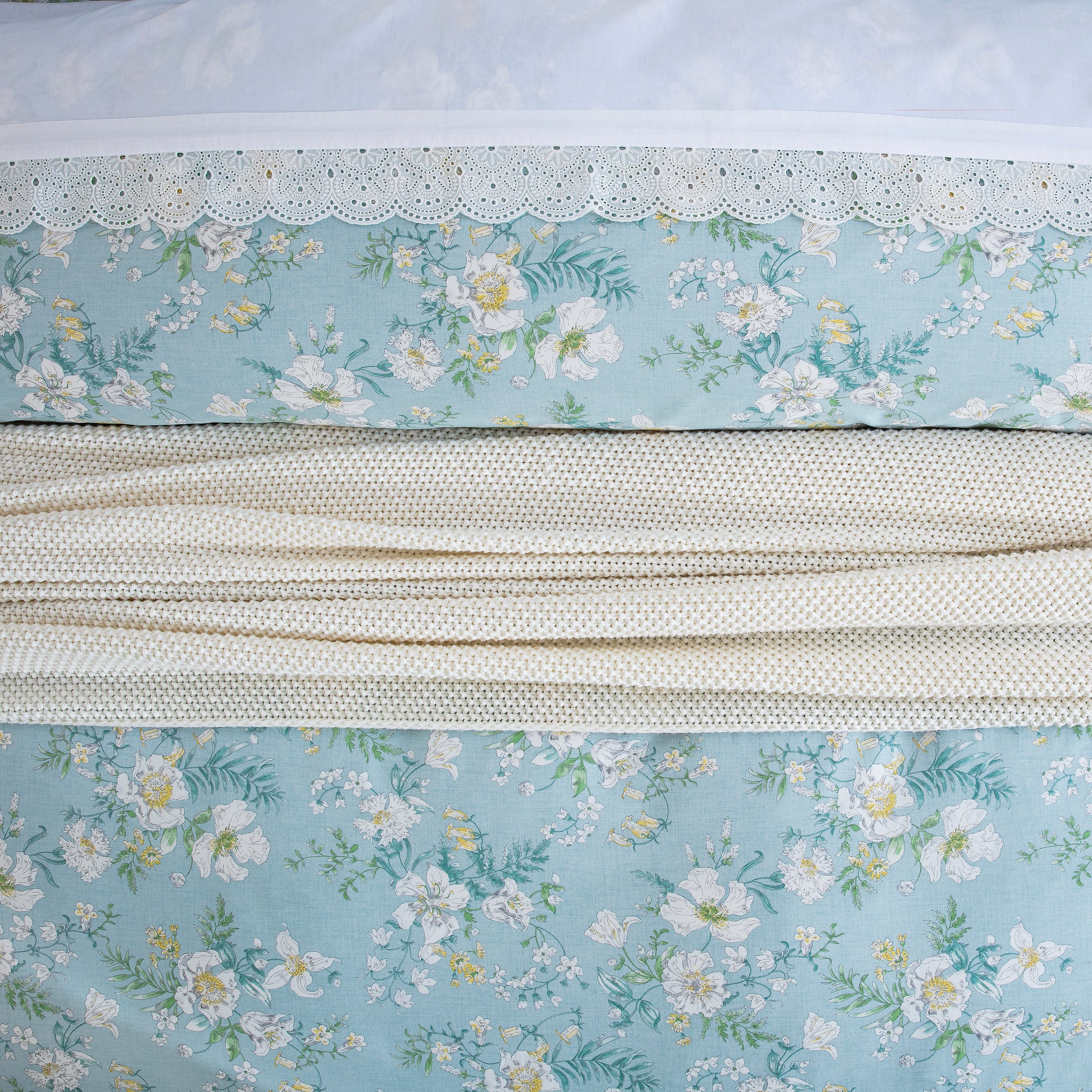 Close-up showing the elegant layered styling of the DAUAOTO light blue floral duvet cover set.