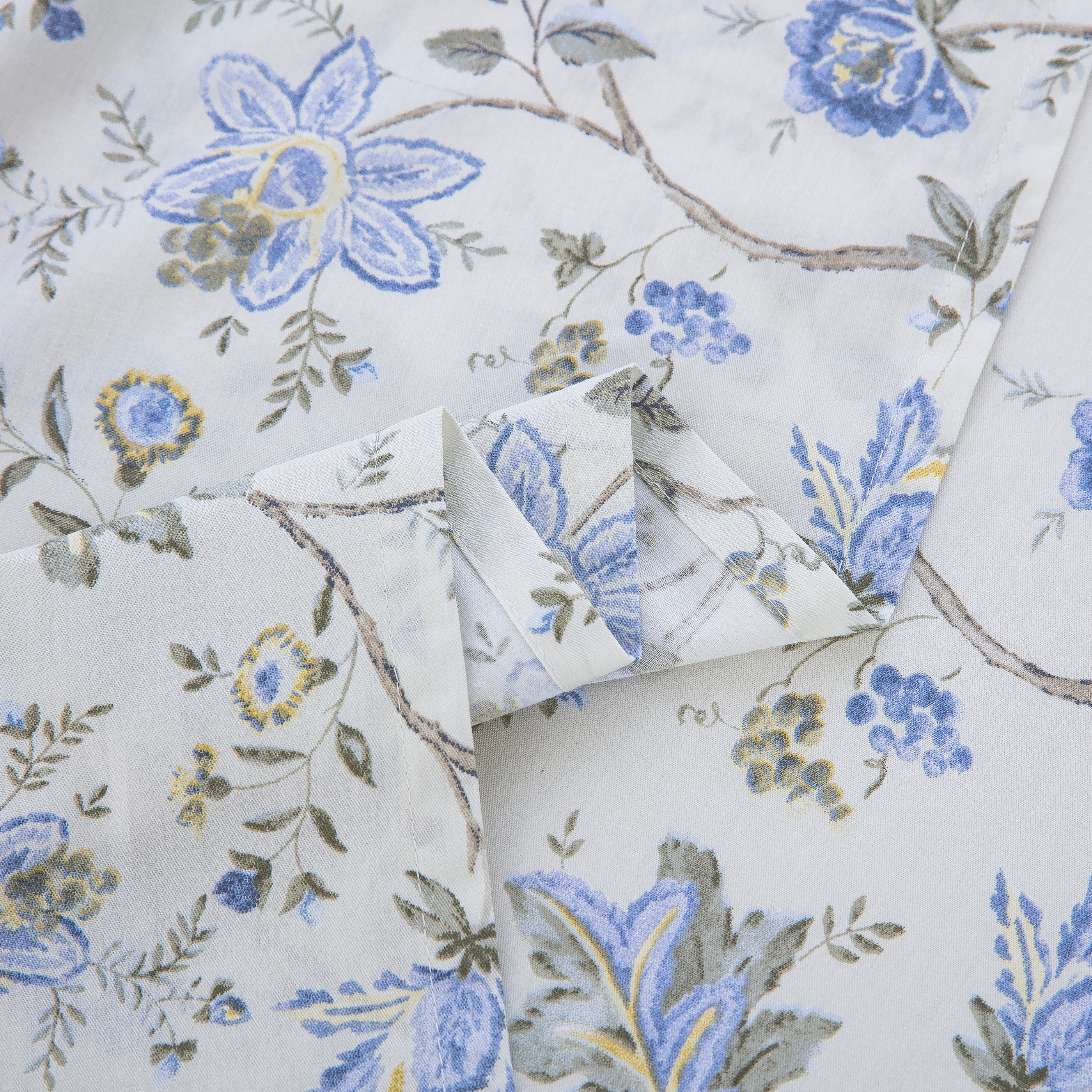 Close-up showing the elegant folded edges and vibrant print of the DAUAOTO French country blue botanical cotton sheets.