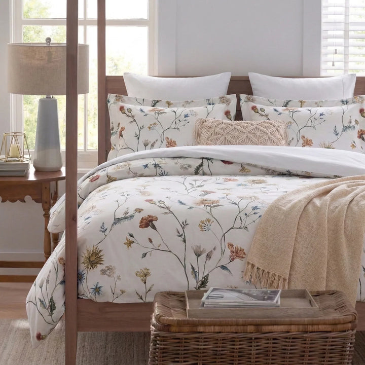 Crisp white bedding with multi-colored botanical print in a cozy cottagecore bedroom setting - DAUAOTO