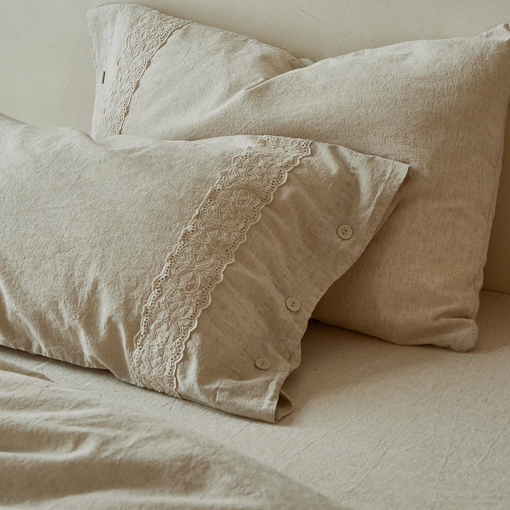 Stacked DAUAOTO Provence linen-cotton pillow shams displaying beautiful embroidered lace details.