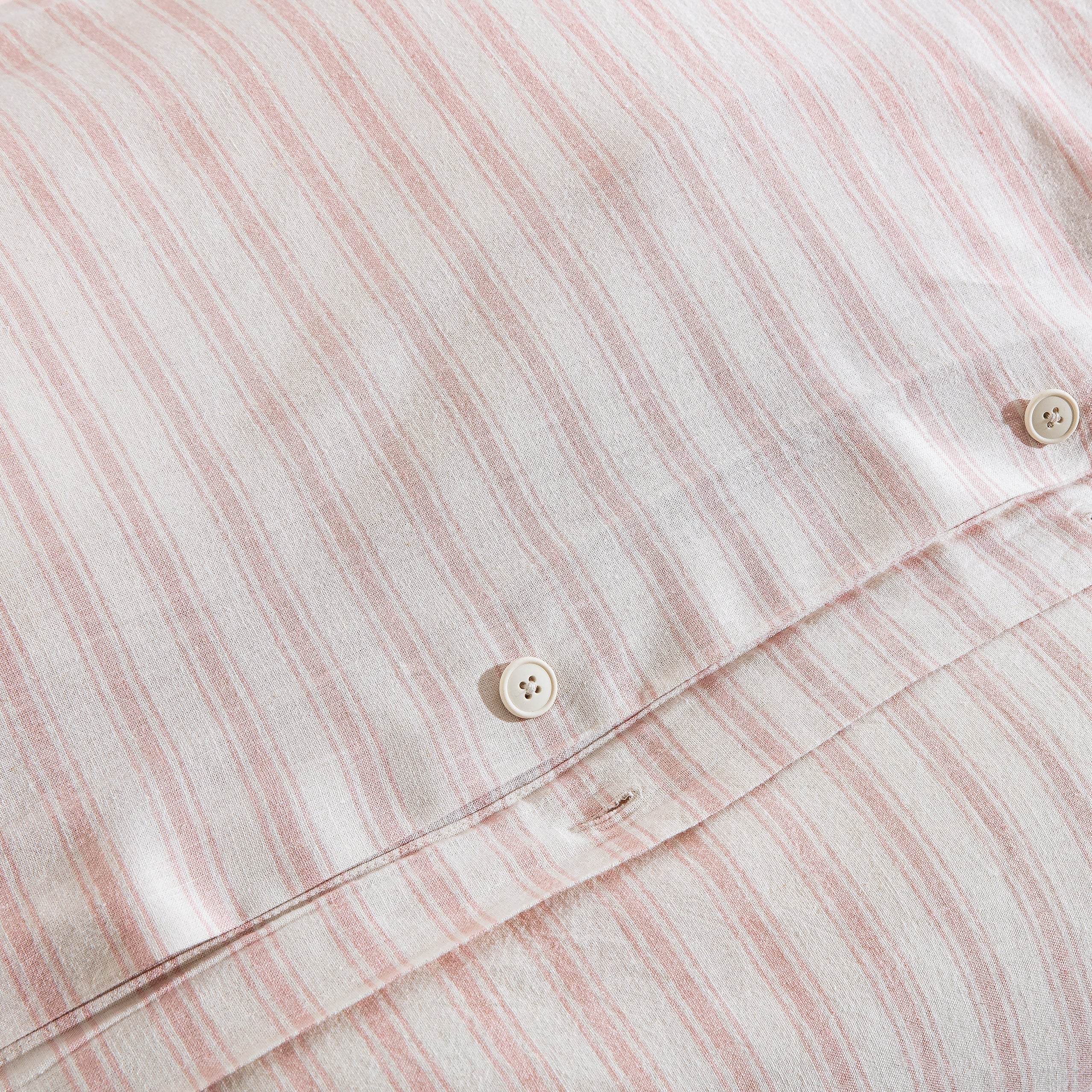 Premium craftsmanship featuring a discreet hidden button closure on the blush pink stripe duvet - DAUAOTO