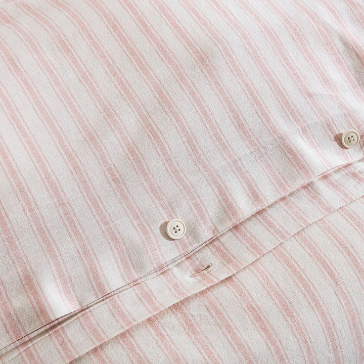 Premium craftsmanship featuring a discreet hidden button closure on the blush pink stripe duvet - DAUAOTO