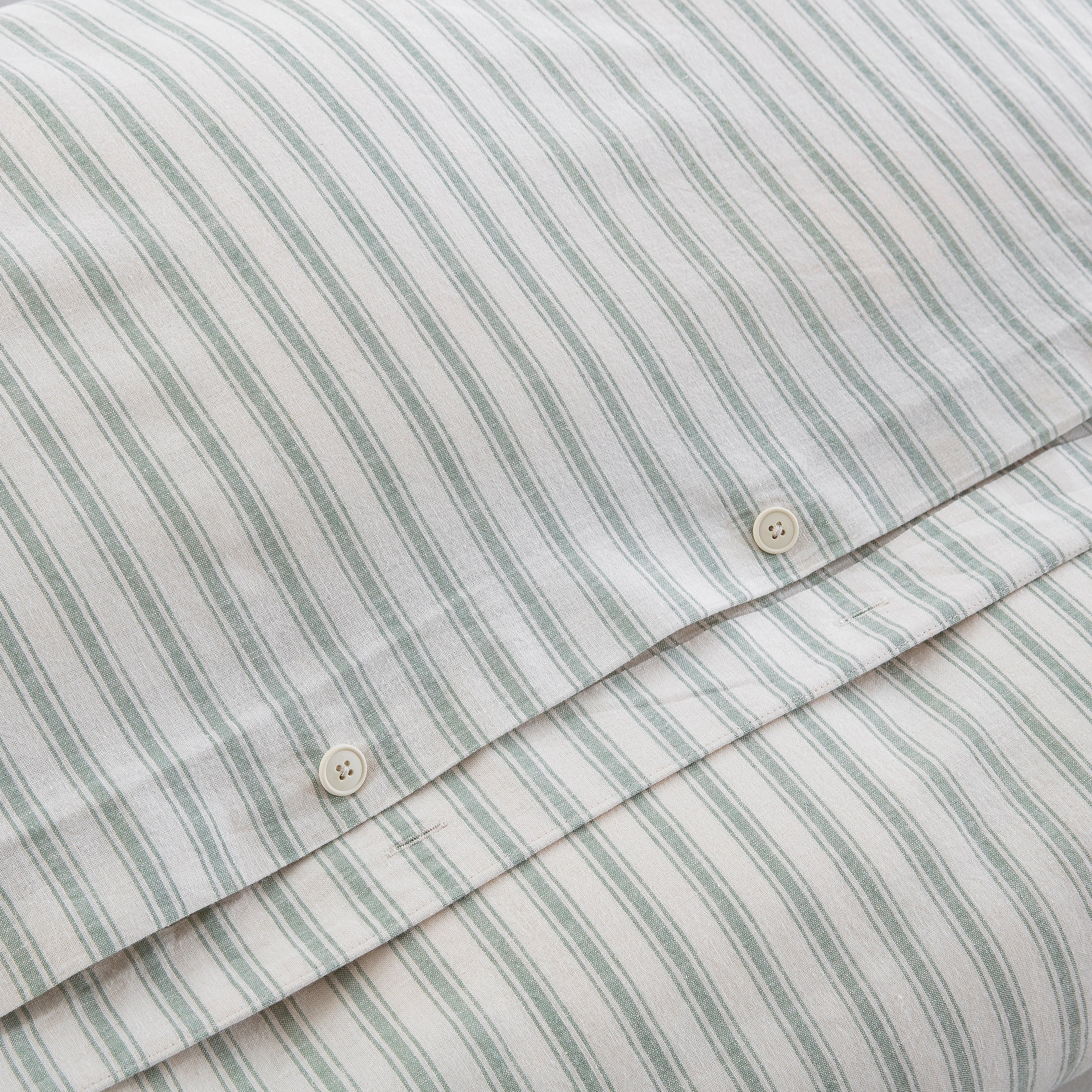 Premium craftsmanship highlighting the discreet hidden button closure on the sage green yarn-dyed stripe duvet - DAUAOTO