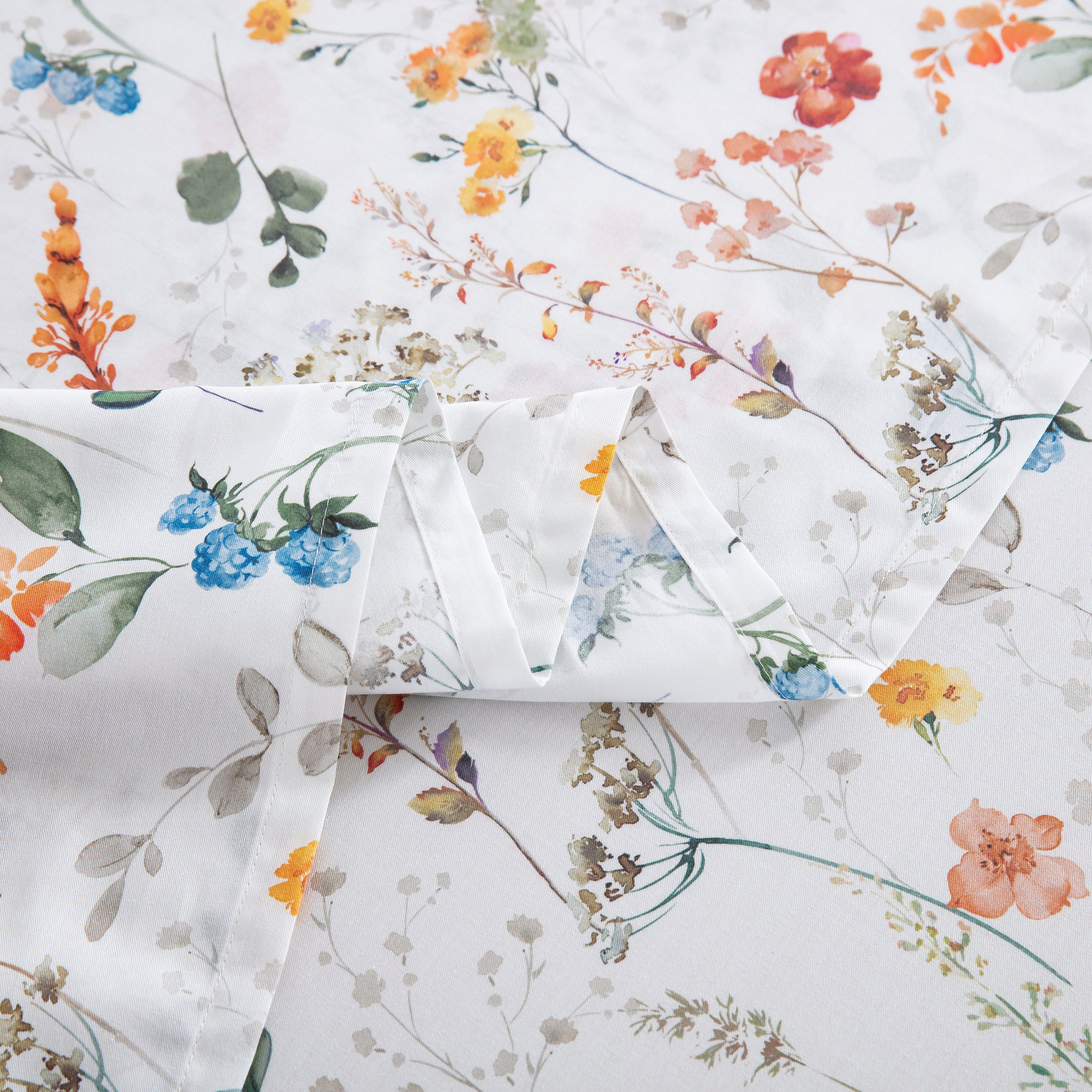 Detailed view of the charming allover print of watercolor botanical wildflowers to breathe life into a neutral room - DAUAOTO