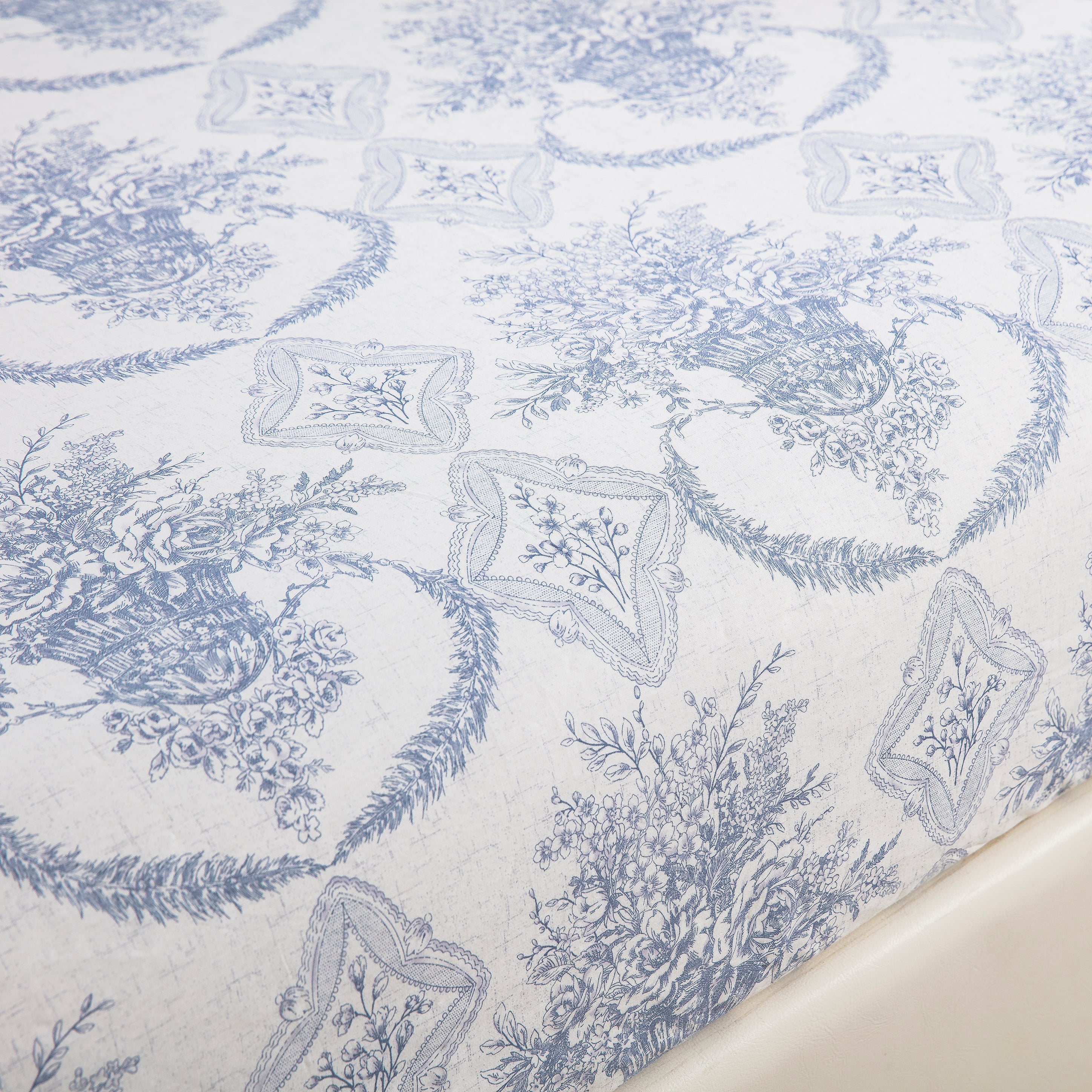 Close-up of muted blue toile print against a crisp white ground on ultra-soft pure cotton fabric - DAUAOTO