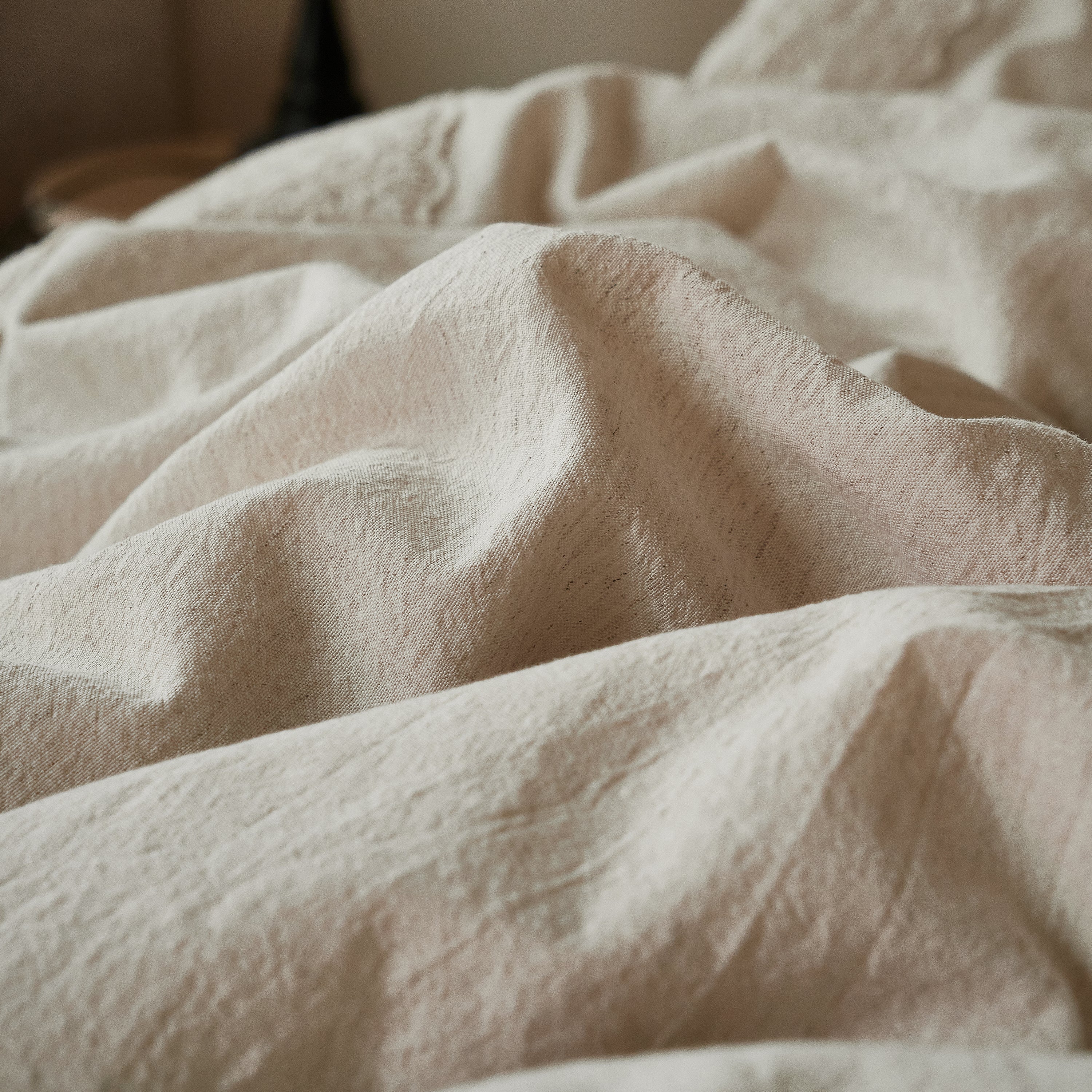 Close up showing the breathable, naturally crinkled texture of the 40% linen 60% cotton blend fabric.