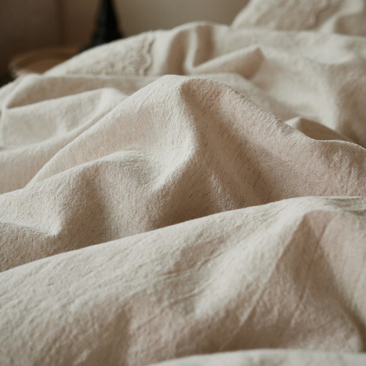 Close up showing the breathable, naturally crinkled texture of the 40% linen 60% cotton blend fabric.