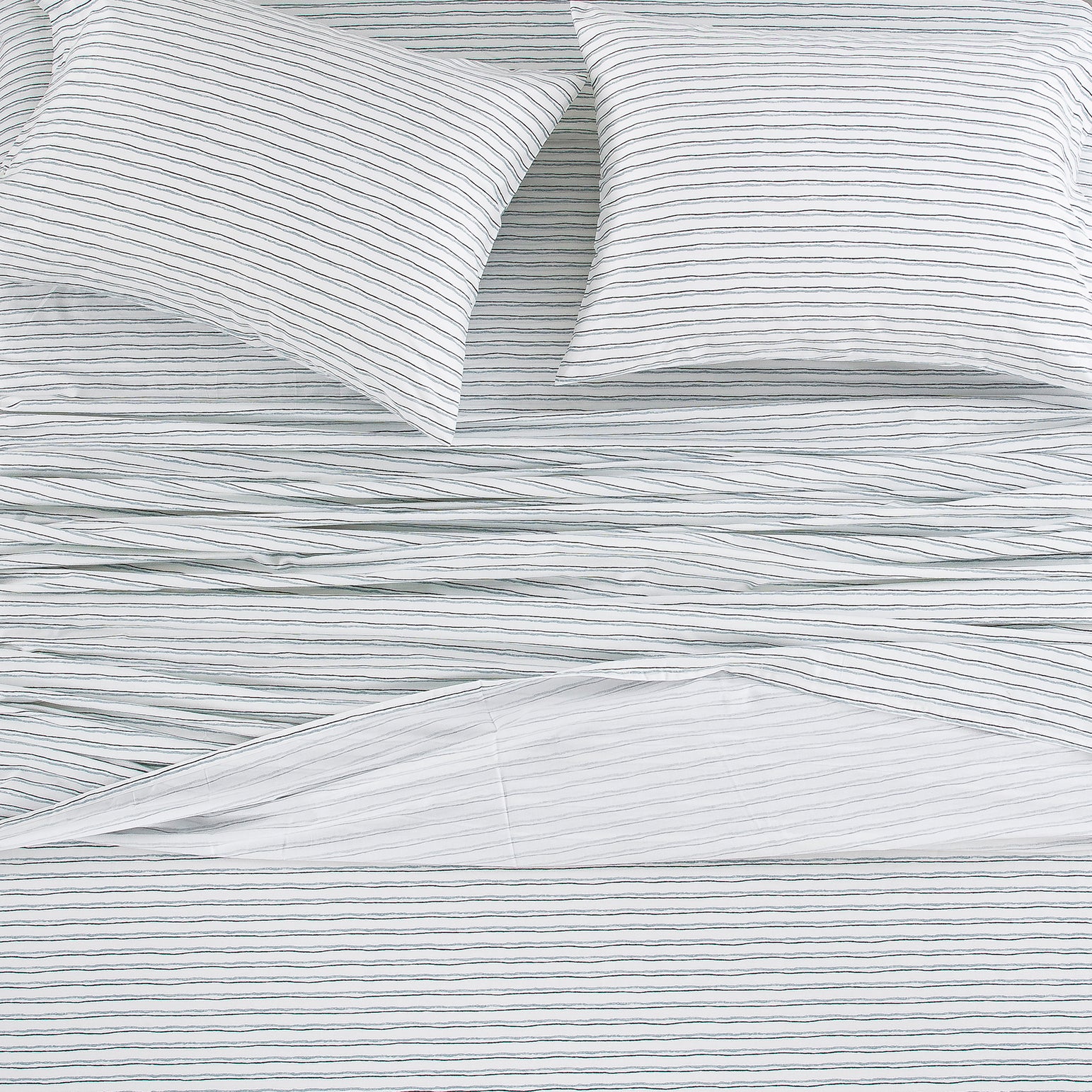 Top-down view of the Scandinavian style bedding with a sketch-like striped pattern on a crisp white ground - DAUAOTO