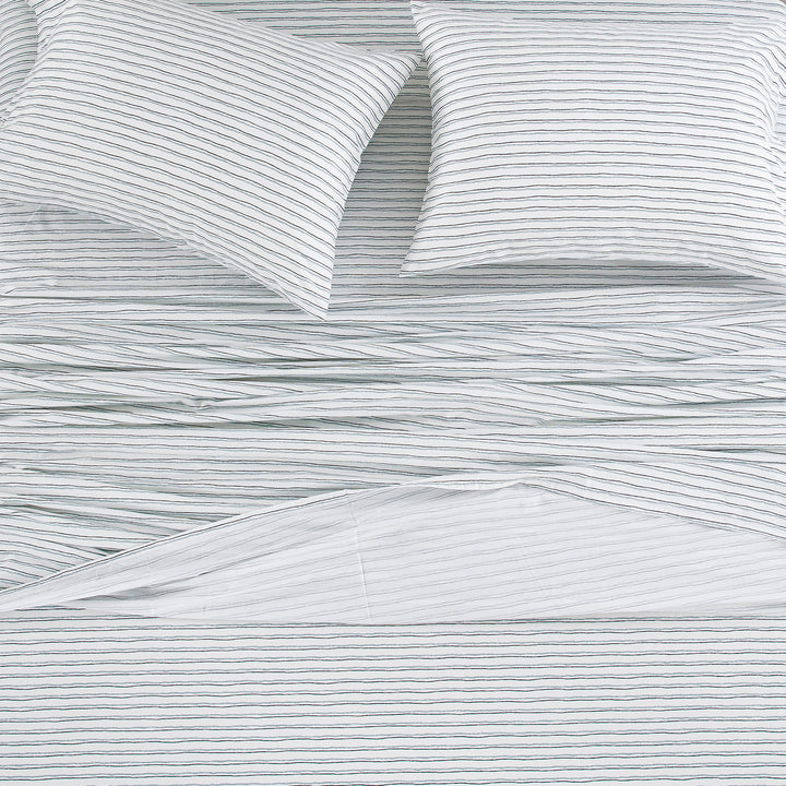 Top-down view of the Scandinavian style bedding with a sketch-like striped pattern on a crisp white ground - DAUAOTO