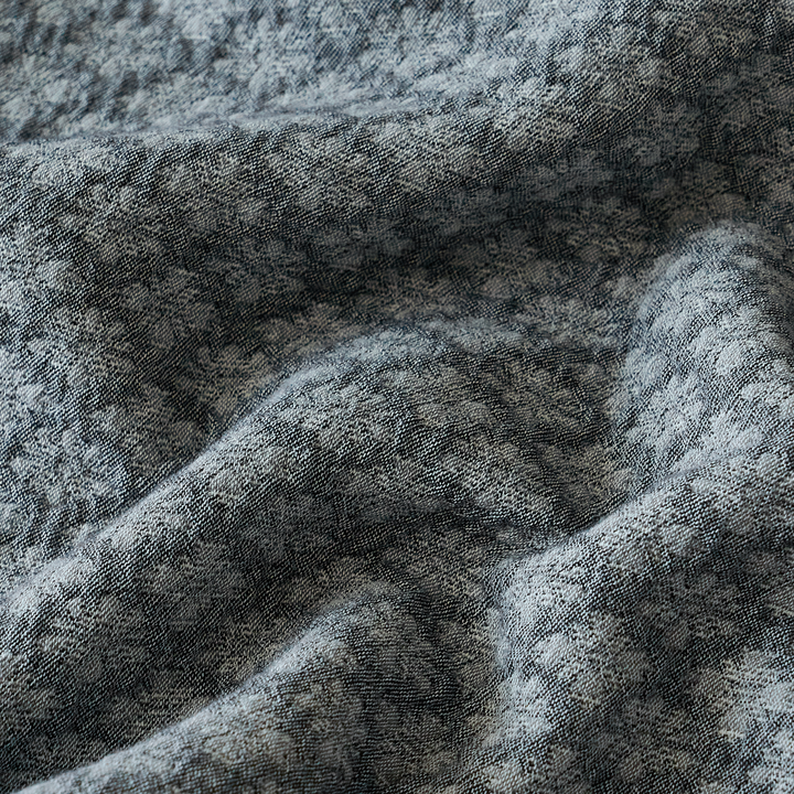 Close-up of soft slate blue washed cotton fabric with natural texture and subtle variations