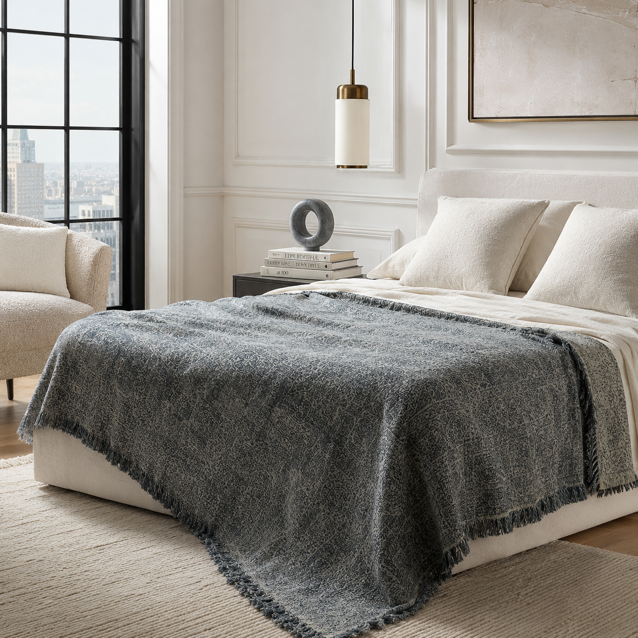 Full view of a slate grey cotton-linen throw used as a summer bedspread in a modern bedroom.