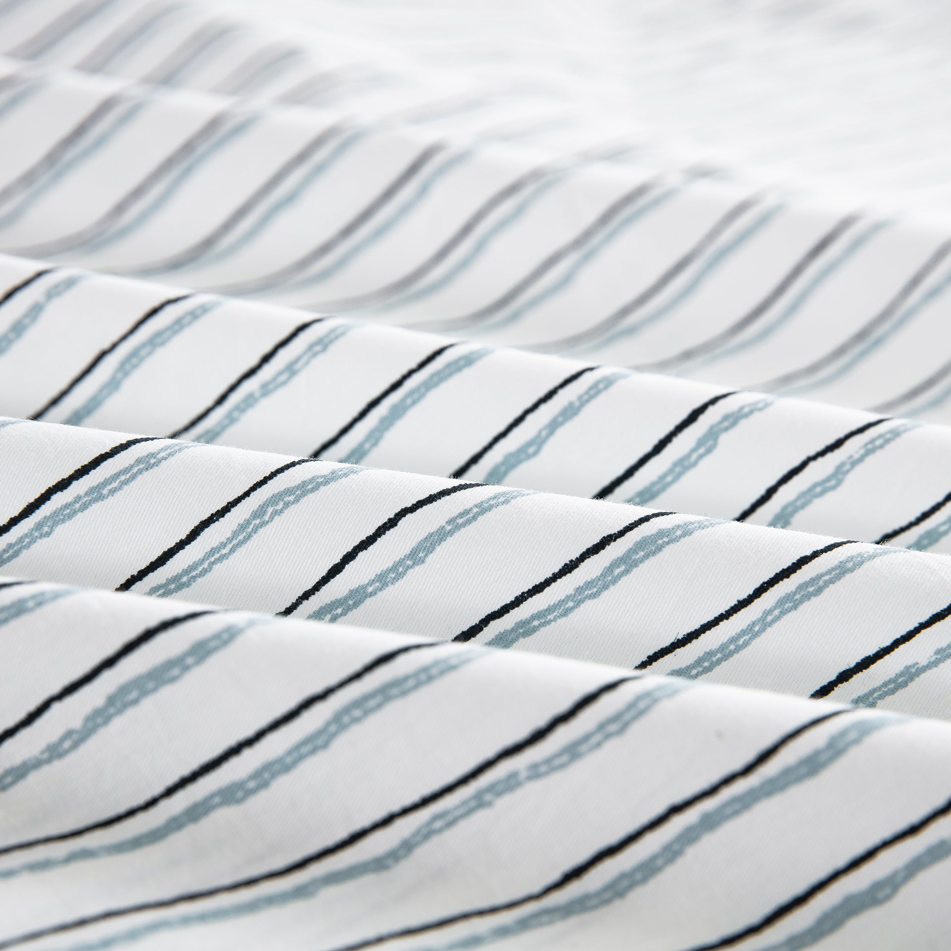 Close-up of the ultra-soft 100% pure natural cotton fabric with lively sketch-like stripes in charcoal and blue - DAUAOTO