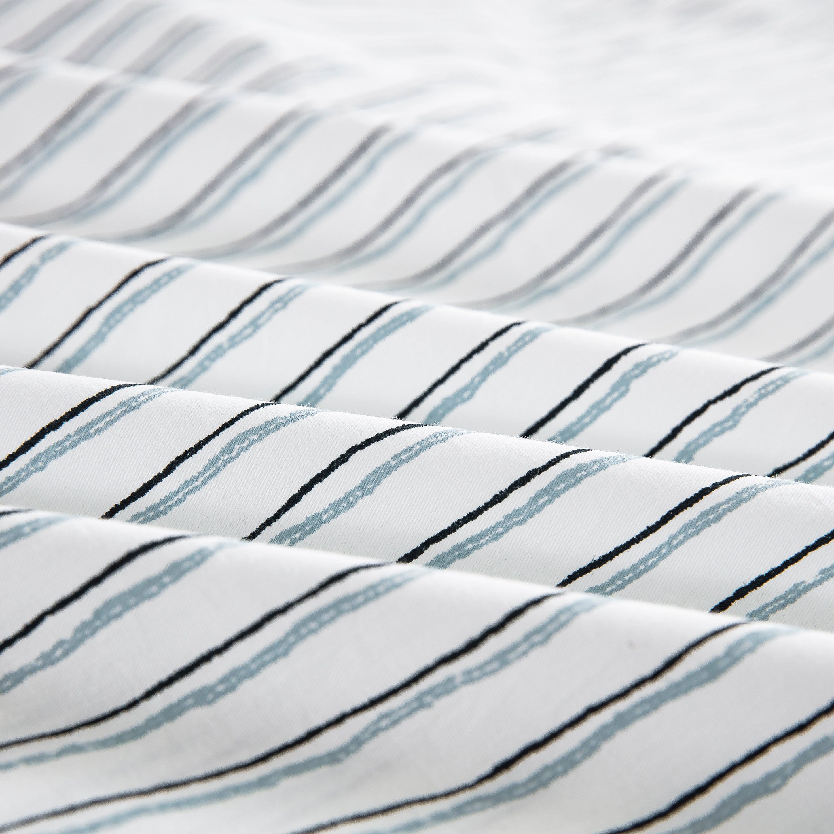 Close-up of the ultra-soft 100% pure natural cotton fabric with lively sketch-like stripes in charcoal and blue - DAUAOTO