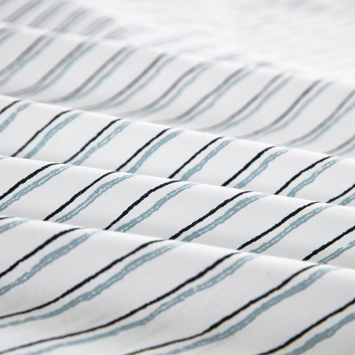 Close-up of the ultra-soft 100% pure natural cotton fabric with lively sketch-like stripes in charcoal and blue - DAUAOTO
