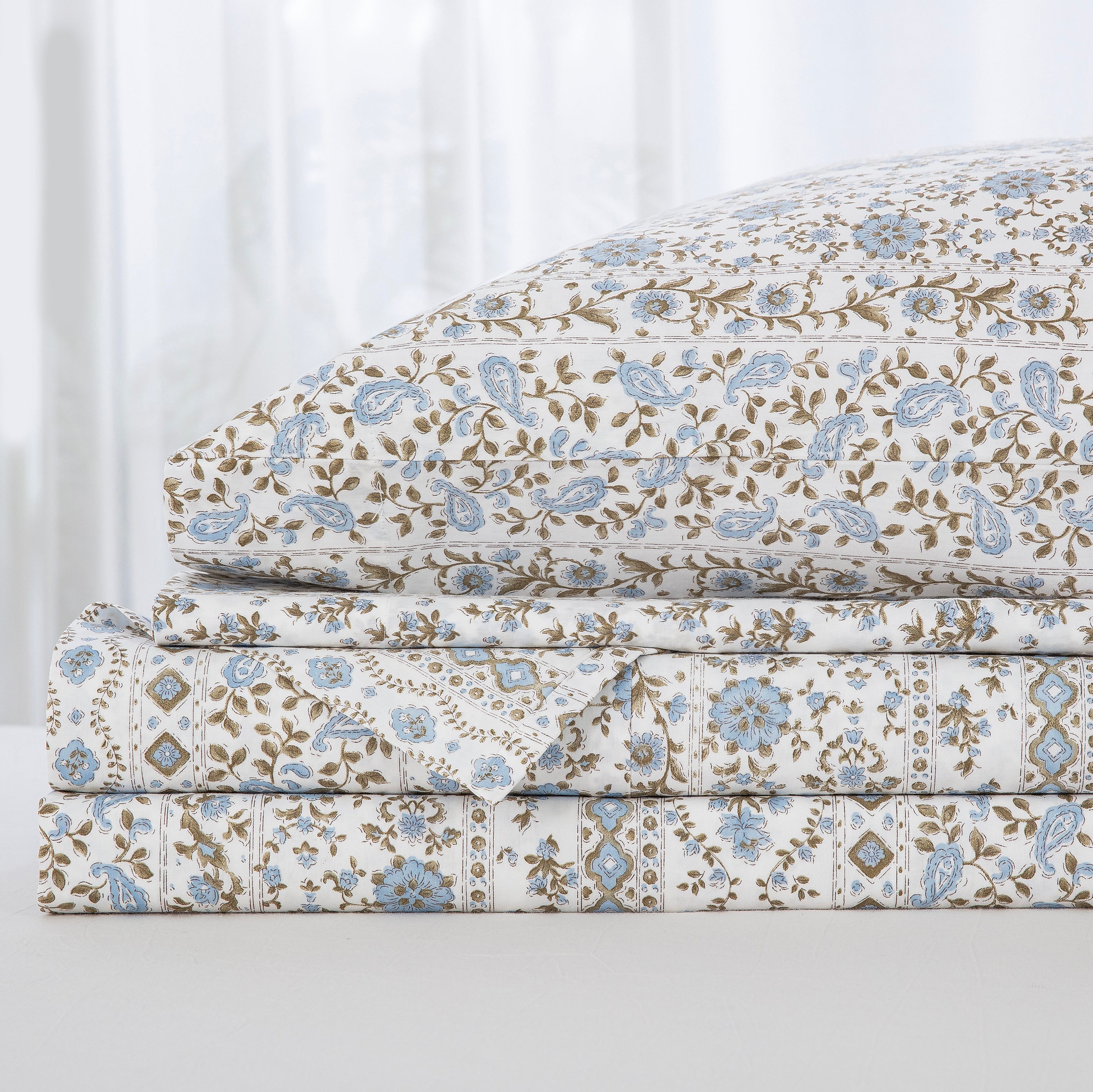 Neatly folded and stacked DAUAOTO coastal blue block print 100% cotton sheet set, showcasing the flat sheet, fitted sheet, and pillowcases.